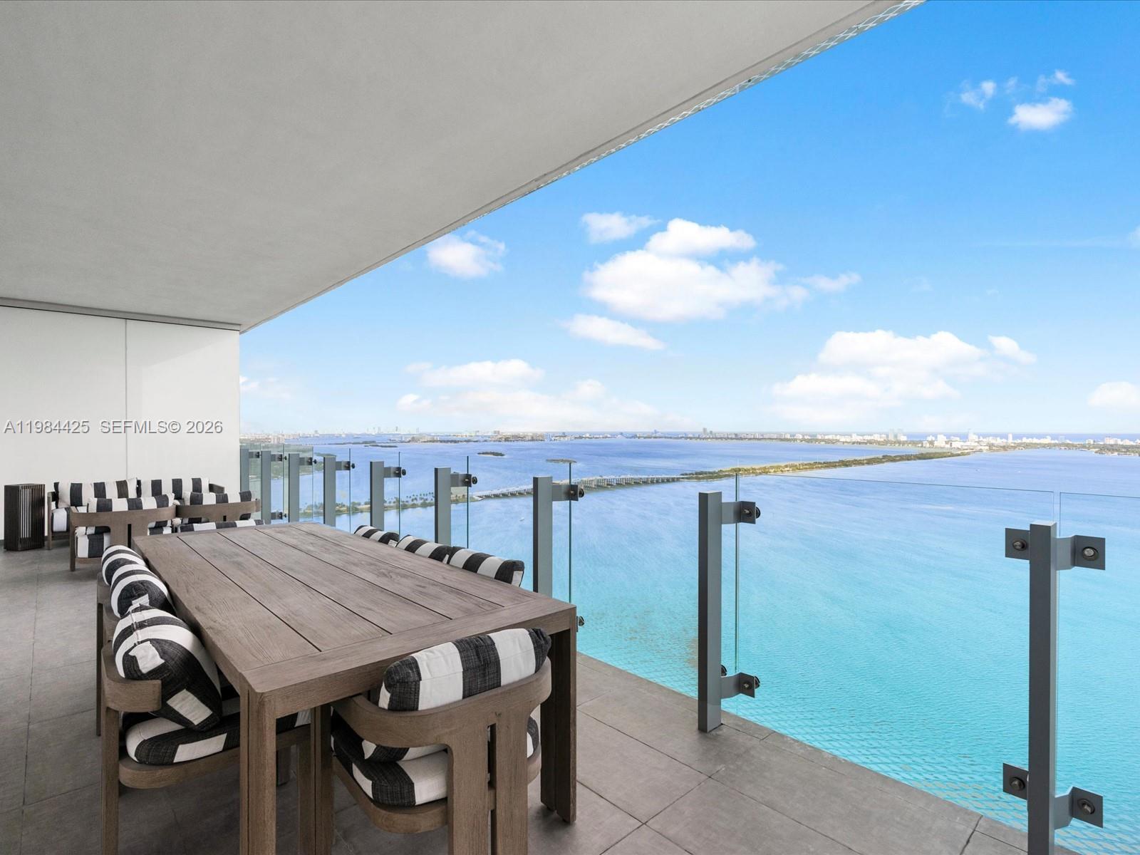 Experience elevated waterfront living on the 42nd floor of Missoni Baia in Edgewater. Spanning 3,788 square feet of interior space with an additional 585 square feet of terraces, this exceptional turnkey flow-through residence offers 4 bedrooms plus a family room and service quarters and 6 bathrooms, blending expansive design with refined luxury. Two private terraces capture both sunrise and sunset, with a 10-foot-deep bayfront terrace and an 8-foot-deep city-facing terrace, ideal for seamless indoor outdoor living and entertaining. Floor-to-ceiling glass throughout frames breathtaking direct-water views, showcasing the ocean, Biscayne Bay and the Miami Beach skyline from every principal room. The open-concept eat-in kitchen features sleek European cabinetry, premium Sub-Zero and Wolf appliances and generous counter space, designed for both everyday living and hosting. Spacious walk-in closets and spa-like bathrooms complete the primary suite experience with comfort and sophistication. Missoni Baia offers unparalleled amenities including 200 feet of bay frontage, an Olympic-length lap pool, kids' splash pad, outdoor spa, yoga studio, state-of-the-art fitness center, wellness spa, hair and nail salon, pet spa, tennis court, game room with billiards and bar, screening room, valet, concierge and 24-hour security. Ideally located in Edgewater near the Design District, Wynwood and Downtown Miami and minutes to South Beach and the Miami International Airport.