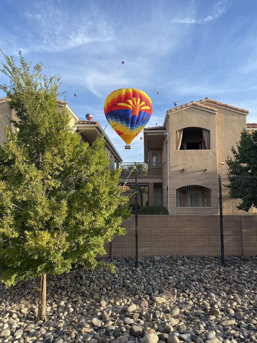 Beautifully maintained 1 bedroom 1 bath ground floor condo in an established gated community. The covered patio has great views of the park, which serves as a popular launch site for balloons during the Balloon Fiesta. This open-concept home features a spacious kitchen with a gas stove and dishwasher, disposal and refrigerator. Washer and dryer included. Each unit has an assigned exterior parking space and an assigned garage. Short walk to small community lawn area with covered seating for dog walks. Community amenities include two pools, a clubhouse, and a fitness center. Duke City inspection recently completed!