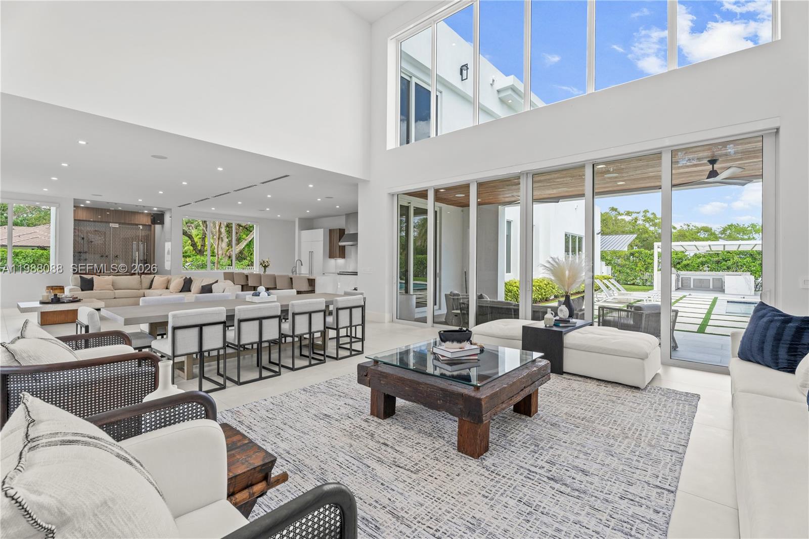 An exceptional gated Pinecrest estate on a corner lot spanning over 37,000 sqft. Architecturally designed to perfection w an open floor plan that flows beautifully. Glass sliding doors, volume ceilings, & abundance of natural light seamlessly blend indoor/outdoor living. Chef's kitchen with Wolf/SubZero appl, custom cabinetry, quartz counters, wine cellar & walk-in pantry. The primary suite is a true retreat with a spa bath, dream closets & a modern fireplace. Italian built-in closets w interior lighting in all bedrooms. Smart home technology, electric blinds, & generator. Air-conditioned 3 car garage with epoxy floors & custom built-ins. A spectacular backyard with a resort-like pool, summer kitchen & soccer field. Located near top-rated private schools, golf course & exclusive yacht club