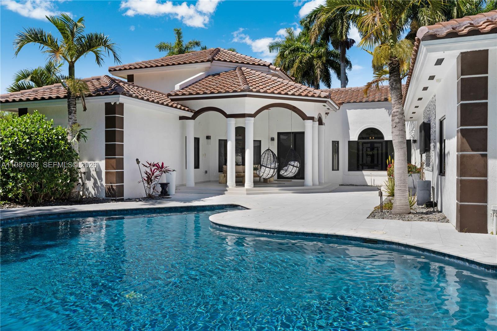 Welcome to Casa Bella! This Italian–inspired Mediterranean retreat in central Palmetto Bay is a serene resort-style paradise, sitting on a privately walled-and-gated, oversized 26,571 SF lot with an impressive wraparound driveway adding exceptional curb appeal. This beautiful home features 5 spacious bedrooms, 4 bathrooms, a brand-new barrel tile roof, and a 10-car motor court. It is also a fully functioning smart home, providing the comfort and luxury of controlling lights, A/C, and a sound system all from your phone. Extra-large windows let in abundant natural light, and the tropical outdoor living space features an outdoor kitchen/bar, heated pool, fire pit, gazebo, and evening sunsets peaking over the rooftops, perfect for entertaining and enjoying South Florida outdoor living at its finest. Steps from top schools, trails, and the bay. Tranquility, design, and location in perfect harmony.