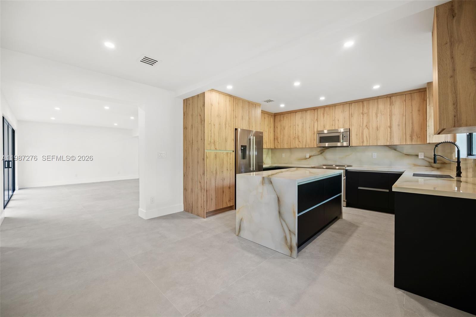 Modern kitchen with designer features at 235 91st St - Home in Miami Shores