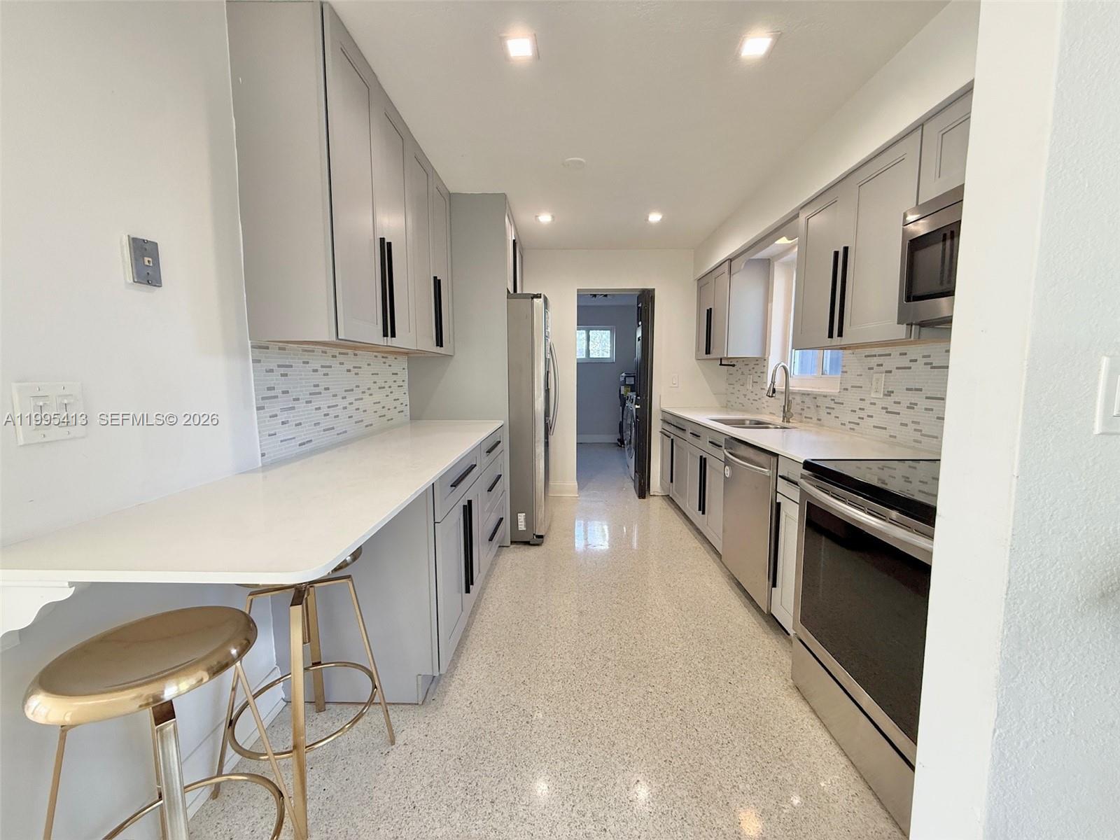 Modern kitchen with designer features at 207 12th Ave - Home in Dania Beach