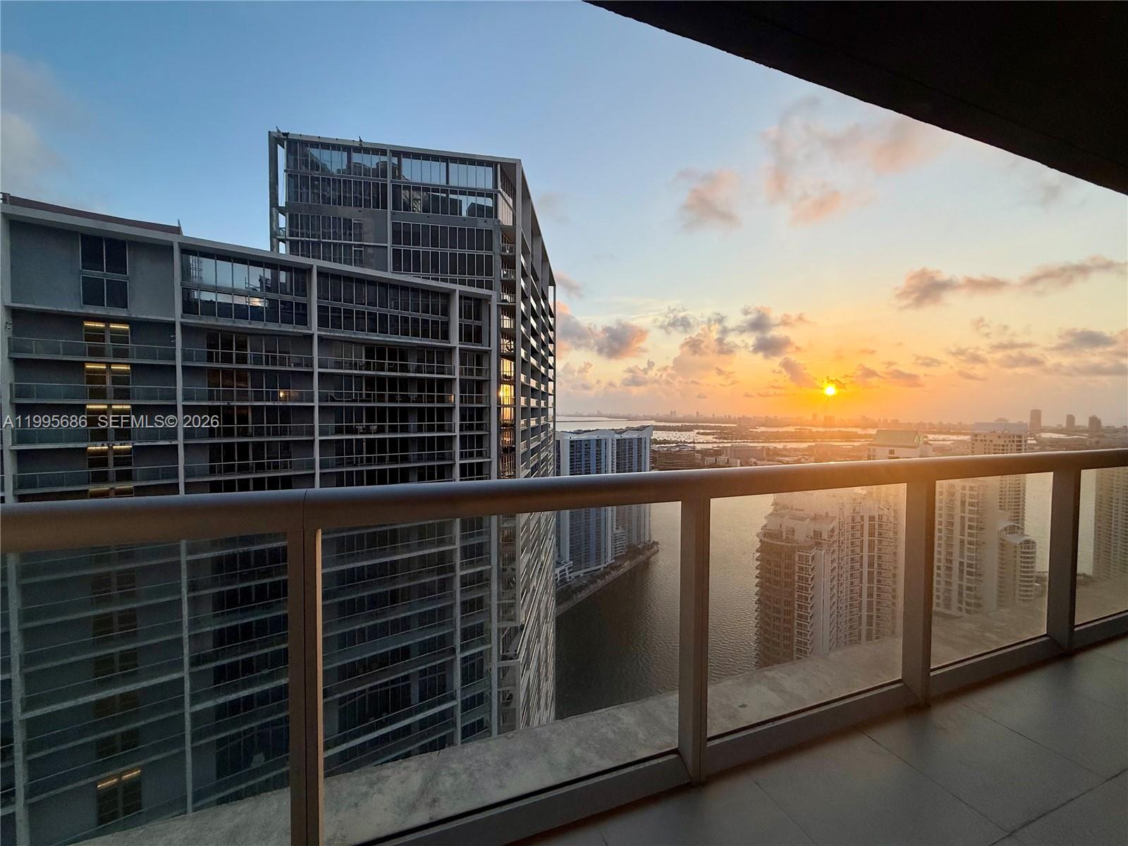 PRICED TO SELL! Perched on the 51st floor, this renovated, fully furnished, turn key residence offers sunrise and waterfront views high above Brickell. Every detail was intentionally curated—from Sub-Zero/Wolf appliances and custom cabinetry to the invisible induction cooktop—creating a minimalist sanctuary that blends warmth with sophistication. Large-format porcelain floors, integrated smart home system, cerused white wood and boucle furniture creates a clean neutral palette that elevates the space. World-class amenities include a spa, fitness center, 1-acre pool deck, and more—within one of Brickell’s most iconic addresses by Philippe Starck with seats to Bayfront Park’s fireworks from the comfort of your home. View not affected by upcoming 75-story Nobu tower. Stucco project underway but NO special assessment with completion slated for Sept-Nov 2026. Cats, cat tower/bed and air purifier in living room excluded from sale. Owner/Broker/Designer.