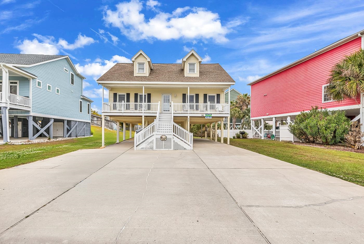Welcome to your perfect coastal escape in the heart of Garden City/Murrells Inlet! This beautifully maintained raised beach house offers 3 bedrooms and 2.5 bathrooms, perfectly positioned just steps from the sand—approximately 450 feet to the ocean—with ocean views right from your driveway.  Designed for both relaxation and functionality, the home features a primary bedroom on the main living floor, while two spacious guest bedrooms upstairs provide plenty of room for additional beds or bunk setups—ideal for hosting family, friends, or maximizing rental potential. Whether you're searching for a second home or an income-producing property, this one checks all the boxes.  Enjoy coastal breezes from multiple porches, all upgraded with low-maintenance Trex decking, including the stairs—built for durability and easy living. Offered fully furnished and truly turn-key, you can start enjoying weekends at the beach or welcoming guests immediately after closing.  Located less than a mile from the Garden City Pier and close to all the charm, dining, and entertainment of Murrells Inlet, this home sits in one of the most desirable areas along the Grand Strand.  If you’ve been waiting for the right beach house—this is it.  Pool images reflect a proposed design the seller has explored; the pool has not been installed.