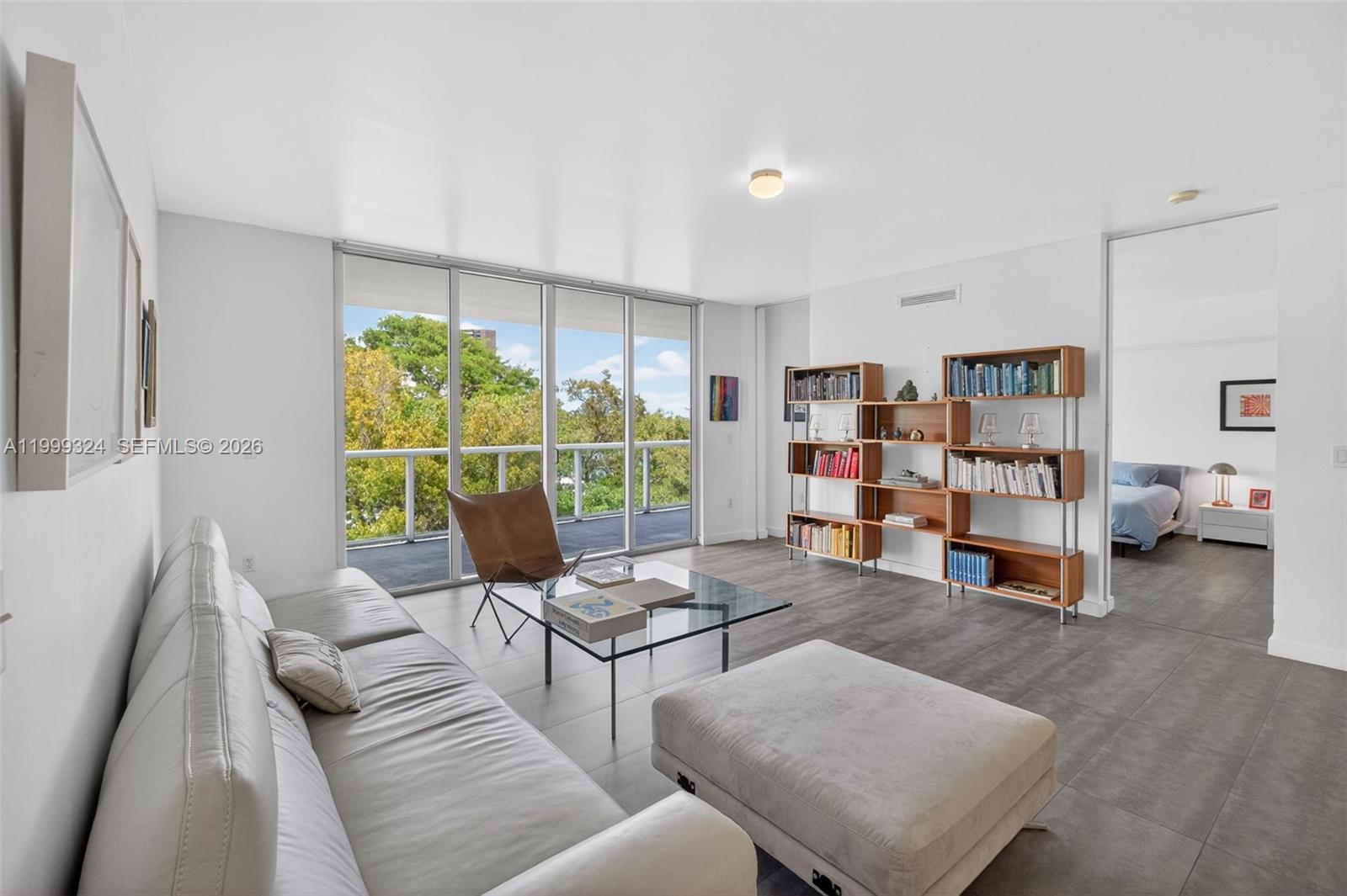 IOS on the Bay is a beautifully designed 5-story, 43-unit boutique condominium built in 2008. Situated on the 4th floor, this spacious and thoughtfully laid-out residence offers over 1500sf of indoor and outdoor living with lush treetop and bay views from every room. A standout feature is the expansive, deep balcony that spans the entire length of the unit. Covered by the building’s architectural overhang, it creates a true indoor-outdoor living experience, ideal for relaxing or entertaining year-round. Interior highlights include large-format tile flooring, high ceilings, floor-to-ceiling pocket doors, walk-in closets, and a large primary bathroom with a glass rain shower. The unit also includes a private storage locker and two parking spaces. The building features a bay front pool overlooking Biscayne Bay, a well-appointed resident gym, and on-site property management. Located east of Biscayne Blvd and directly on Biscayne Bay, IOS is nestled in Miami’s historic MiMo District, with direct access to the Morningside neighborhood and Morningside Park. Enjoy being just steps from a variety of restaurants, shops, the Farmers Market, and entertainment options.