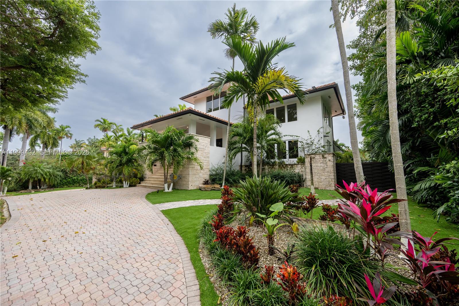 Stunning waterfront mansion w/ modern luxury situated in the elite CocoPlum enclave in the heart of Coral Gables. Boasting 5 opulent bedrooms & 5.5 lavish bathrooms, this contemporary haven features 2 family rooms, maid/in-law quarters, state-of-the-art appliances & amenities, a cutting-edge home gym, upstairs den, versatile 8-car garage convertible into an entertainment hub, & an executive office space. Outdoors, the estate is an entertainer's paradise & perfect for family enjoyment w/ a heated pool, built-in bbq, terraces, trampoline, play set, kayak & jet-ski docks, all on a serene waterfront. Boasting over 95ft of water frontage & dual boat lifts, the residence is a boater's dream, just minutes away from open waters, CocoPlum Yacht Club, Nixon & Key Biscayne! Includes internet + HOA.