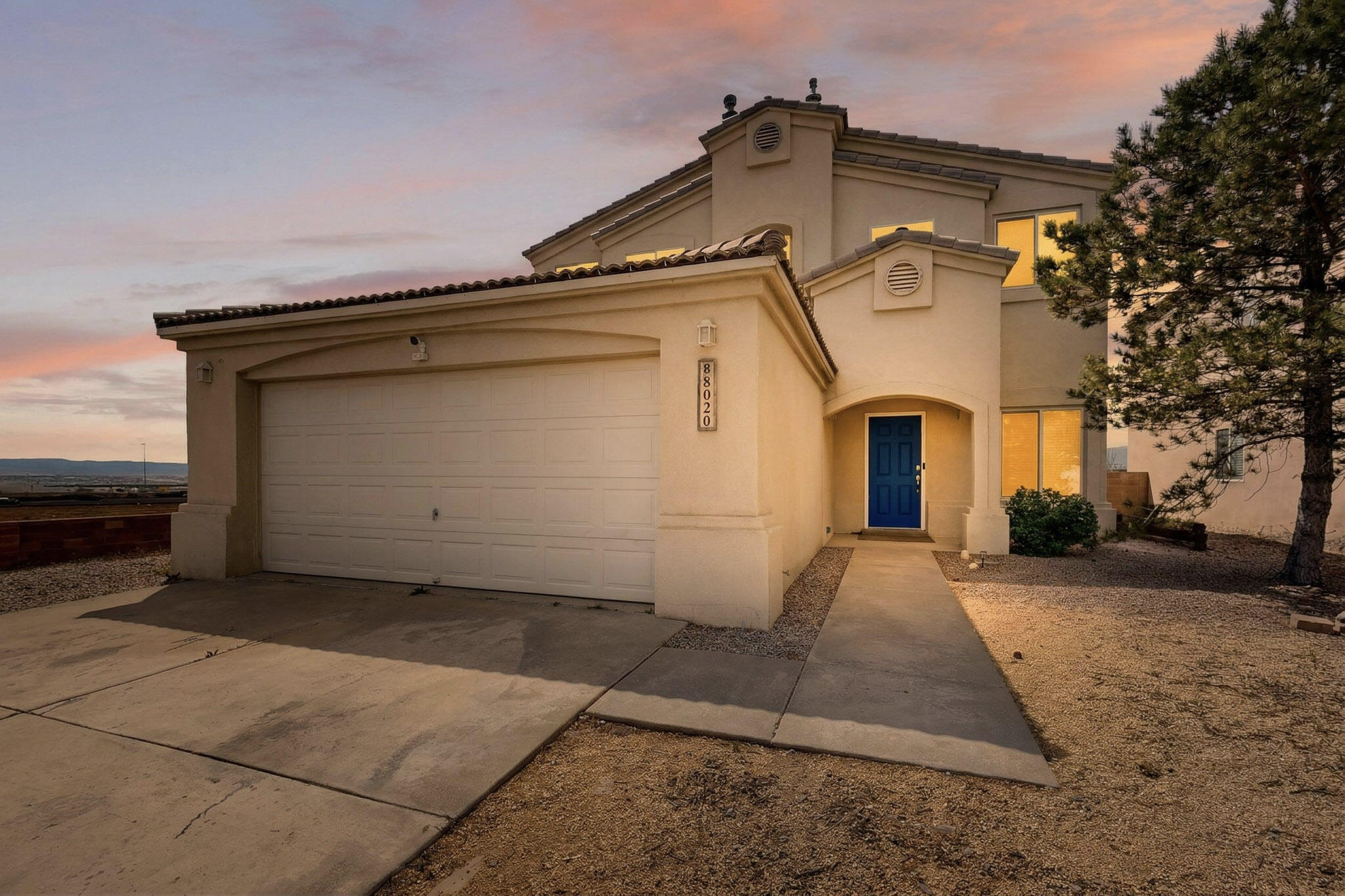 Welcome to 8020 Eliyah Court NW, an exquisitely appointed two-story residence positioned on a premium oversized corner lot in Albuquerque's sought-after northwest corridor. This 3-bedroom, 3-bath home showcases elevated design, modern sophistication, and exceptional functionality. Step inside to discover a light-filled, open-concept interior featuring sleek, no-carpet flooring for a clean, contemporary aesthetic. Dual fireplaces serve as stunning architectural focal points, creating inviting spaces ideal for both refined entertaining and everyday luxury living. The thoughtfully designed layout offers seamless flow between living, dining, and kitchen areas, complemented by stylish, modern finishes throughout . The expansive home provides backyard access and RV parking.