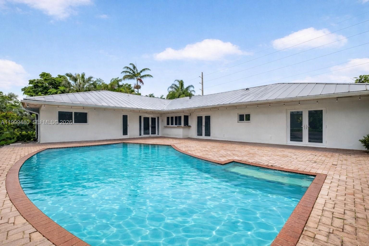 Beautifully maintained home in the heart of Palmetto Bay, offering 4 bedrooms, 2.5 bathrooms and 2,860 SF, set on a lush 18,750 SF corner lot on a quiet, low traffic street.Features a desirable split floor plan with a private primary suite, tile floors throughout, and abundant closet space. Spacious family room and a well equipped kitchen, perfect for everyday living and entertaining. Laundry room with sink adds convenience.Enjoy your private saltwater pool, ideal for relaxing or hosting year round. Additional highlights include a circular driveway, 2 car garage, and durable metal roof. Gas water heater, washer and dryer.Located near top rated schools, including Coral Reef Senior High School and Elementary, plus parks, shopping, and dining nearby. DU required with offer.