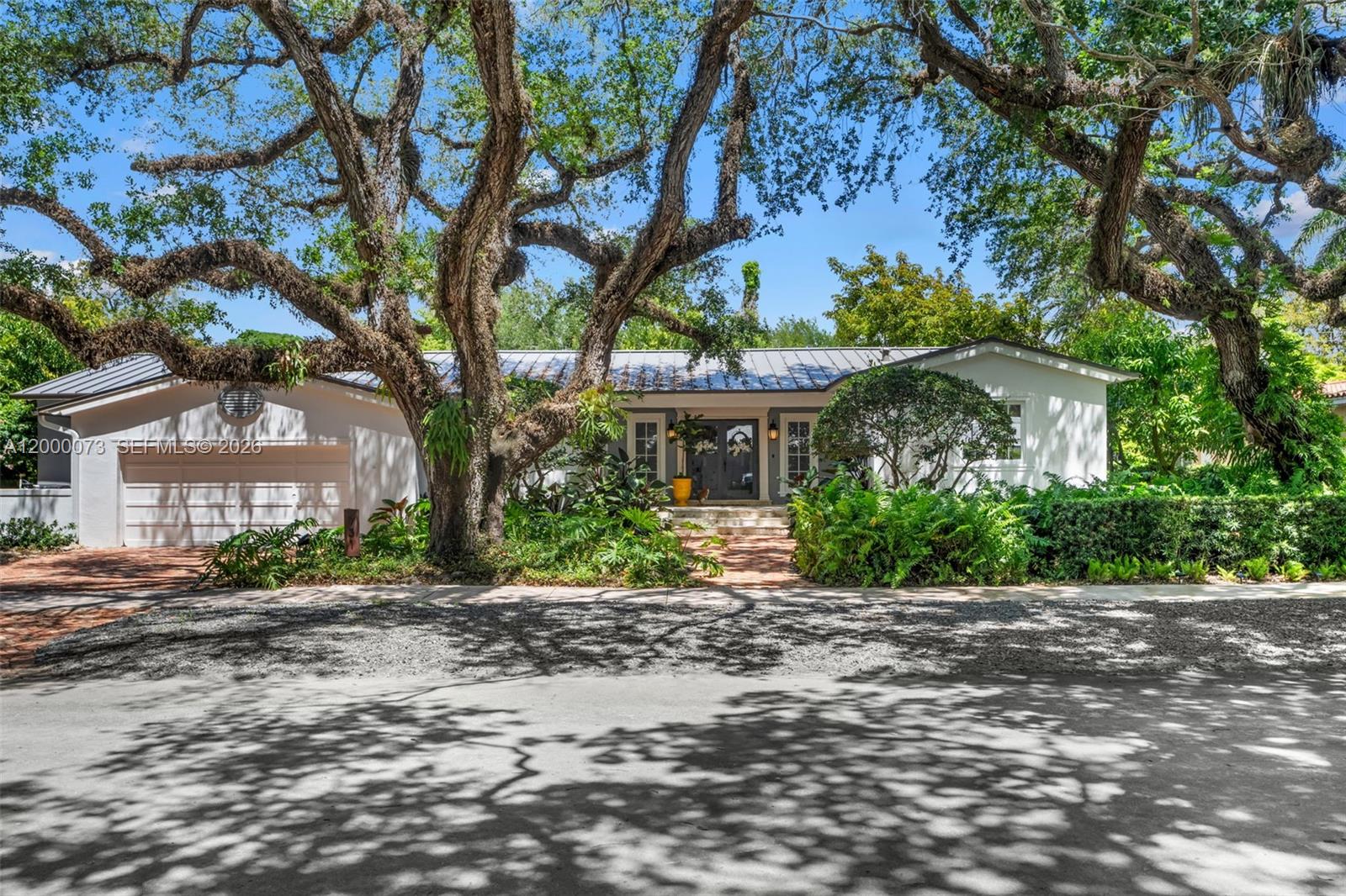 Set on one of the most desirable streets in Coral Gables’ Platinum Triangle, 731 Calatrava Avenue offers timeless architecture, privacy, and exceptional livability. Arched doorways and marble floors define the interiors, complemented by a new metal roof in 2025 and high-impact windows and doors throughout. Outdoors, a large covered patio overlooks a tropical saltwater pool, surrounded by mature landscaping and fruit trees on a 10,000 SF lot. The residence features 3 bedrooms, 3 full baths, and maid’s quarters currently serving as a laundry room off the 2-car garage. A rare offering in an incomparable neighborhood setting.