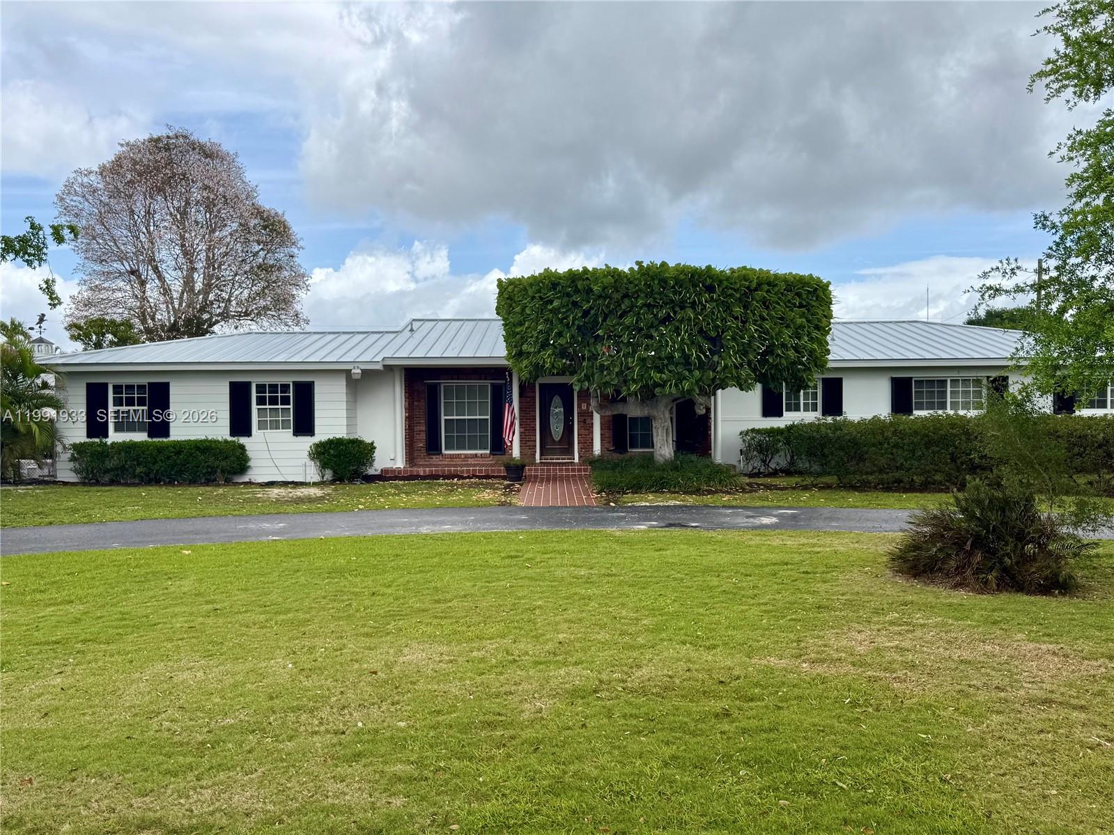 BEAUTIFULLY LOCATED HOME ON 2+ ACRES IN THE REDLAND.  4 BEDS 2 BATH WITH EXTRA ROOM ATTACHED TO SCREENED PATIO.  FULLY AIR CONDITIONED DETACHED 3 CAR GARAGE/WORKSHOP.  ATTACHED GARAGE FOR ADDITIONAL CAR AS WELL!  LARGE POOL WITH SCREEN ENCLOSURE MAKES FOR A LOVELY ENTERTAINMENT AREA. SPACE FOR A HORSE OR TWO! FULLY FENCED BACK YARD. LOVELY LANDSCAPING. NO HOA!!!