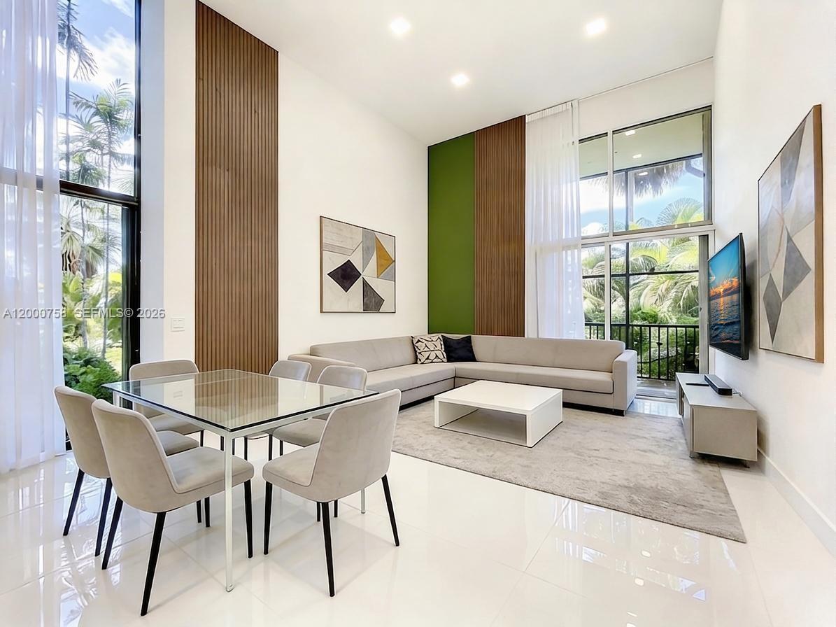 Fully renovated corner townhouse on Aventura Golf Course. Spacious layout with 3 bedrooms, 3 full bathrooms, and 2 dens across approx. 2,000 SF. Architect-designed remodel with permits, featuring vaulted ceilings, bright open living areas, and a gourmet kitchen with new stainless-steel appliances and granite countertops. Private balcony with golf course views.Resort-style amenities include pool, spa, fitness center, and clubhouse. Walking distance to Aventura Mall. Close to major roads and top-rated schools.Move-in ready. Association approval 3–4 weeks.
