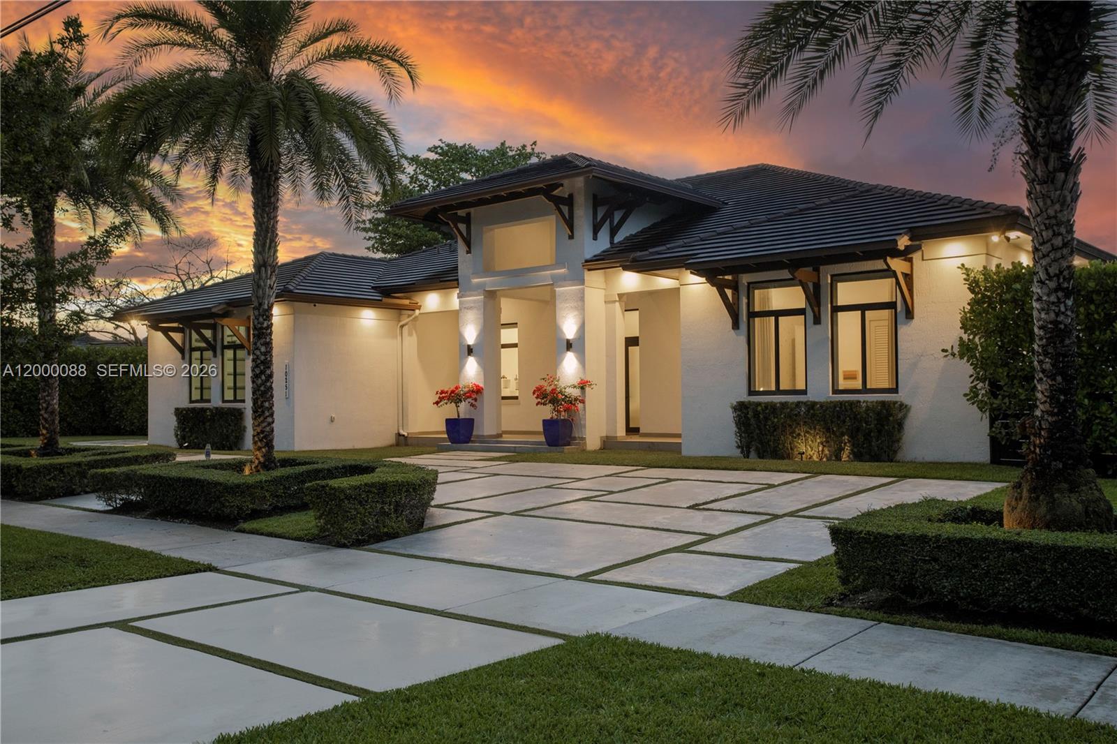 Gorgeous one-story home with 5 bedrooms and 5 bathrooms, featuring a MODERN DESIGN, an open floor plan, and high-end finishes with extensive custom cabinetry and upgrades. NEWER CONSTRUCTION, with high ceilings and expansive IMPACT WINDOWS AND DOORS, bringing in abundant natural light.  The large kitchen is simply spectacular, with premium Thermador appliances and a layout that connects perfectly to the living and dining areas. There’s also a temperature-controlled wine cellar, a great touch for wine lovers.  Situated in an OVERSIZE AND FULLY FENCED LOT, the outdoor space with a large pool with sun shelf and a barbecue island offers great privacy and plenty of room to relax or entertain.  Convenient 2 covered garage spaces. Great location with easy access to Miami Int. Airport, major highways, top schools, shopping, and dining.  Very well maintained and truly move-in ready.  ** A rare find to enjoy the best of the South Florida lifestyle **