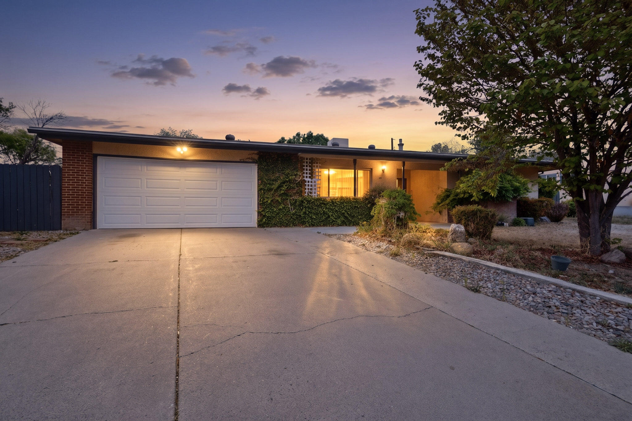 Welcome to this inviting ranch-style home in Northeast Albuquerque featuring 4 bedrooms and multiple living spaces designed for comfort and flexibility. Enjoy a cozy family room and a warm two-way fireplace that connects the living and dining areas, creating a welcoming atmosphere throughout.Step outside to a backyard oasis on a large lot, complete with garden beds and designed for both relaxation and sustainability--perfect for unwinding, entertaining, or enjoying outdoor living.A wonderful opportunity to own a well-cared-for home in a desirable location close to shopping, dining, and parks.