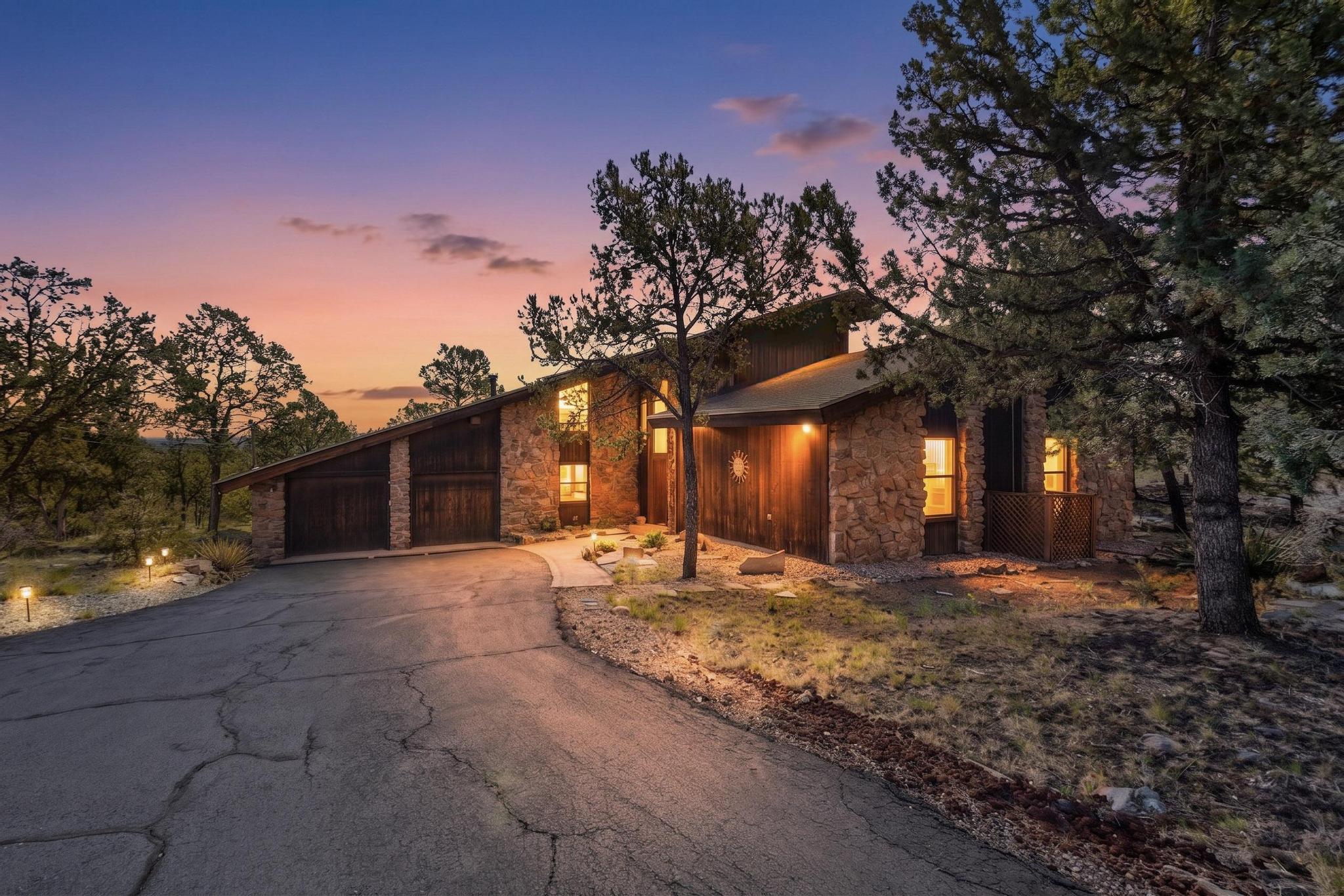 Nestled on 3.57 acres of wooded land in the heart of Cedar Crest, this beautiful 3-bedroom plus loft, 2.5-bath and 5 car garage home offers the perfect blend of privacy, tranquility, and convenience--just minutes from Albuquerque. Surrounded by mature trees and natural landscape, this property provides a peaceful retreat with room to breathe.Step inside to find soaring vaulted ceilings that create an open, airy feel and enhance the home's natural light. The versatile loft space is ideal for a home office, second living area, or guest retreat. The spacious primary suite features a private deck--perfect for enjoying morning coffee or unwinding in the evening while taking in the serene surroundings.Designed for indoor-outdoor living, the
