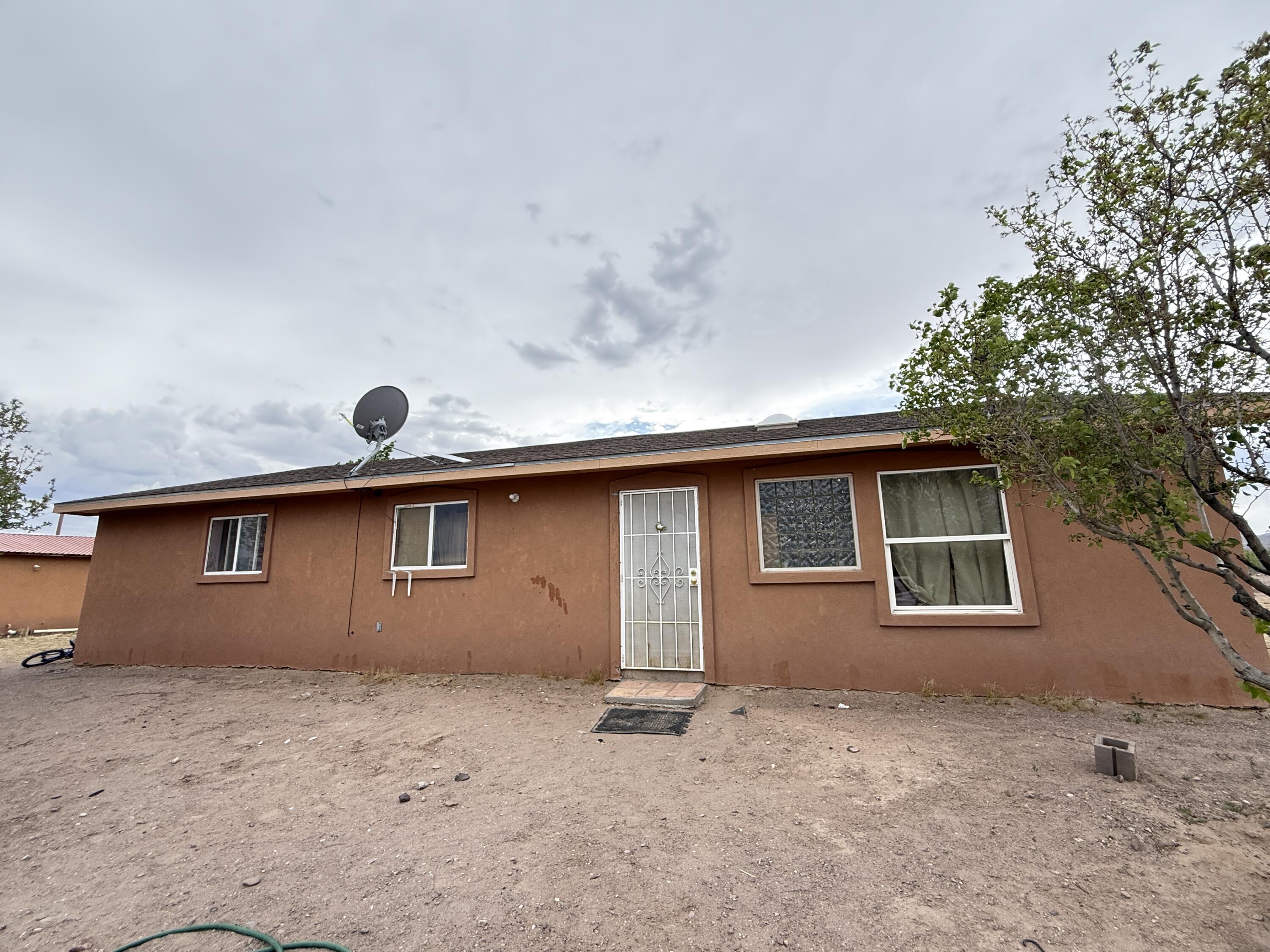 Charming 3 bedroom, 2 bath home offering approximately 1,500 sq ft of comfortable living space with an inviting open floor plan perfect for everyday living and entertaining. Interior features a combination of tile and carpet flooring throughout, central forced air heating, and efficient evaporative cooling for year-round comfort. Enjoy stunning mountainous views and the peaceful natural beauty of the nearby Rio Grande River. Property also includes a detached 361 sq ft casita ideal for guests, extended family, studio space, or potential rental income opportunity. Spacious yard provides room to relax, garden, or take in the surrounding scenery. A versatile property with scenic surroundings and flexible living options ready to fit a variety of lifestyles. All situated on 1 acre.