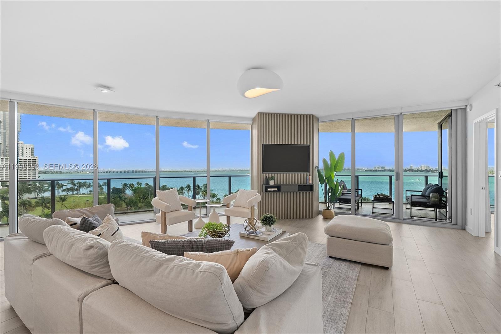 Welcome to Condo Bay at Aria on the Bay — a residence designed to capture Miami from every angle. Wake up to bay views and unwind to the city skyline from a wraparound balcony that extends your living space outdoors. Enjoy the convenience of two assigned parking spaces on the same level as the residence, offering ease similar to private home living. Two private elevators open directly into your exclusive foyer, creating a seamless arrival experience. The layout features 3 bedroom suites, including 2 primary suites with walk-in closets and en-suite bathrooms, plus a third bedroom with its own bath. Each bedroom has direct access to the wraparound balcony, enhancing the indoor-outdoor flow. An enclosed den, currently used as an office, can serve as a fourth bedroom with a full bath. Custom millwork, wallpaper accents, and a built-in bar enhance the living space, complemented by Italian cabinetry, Bosch appliances, and clean finishes throughout. Offering 2,365 SF of interior space and a 613 SF wraparound balcony, the residence also includes two parking spaces on the same level. Aria on the Bay offers resort-style amenities including sunrise and sunset pools, spa, fitness center, yoga studio, theater, and 24-hour concierge. Located near Midtown, the Design District, Brickell, and Miami Beach.