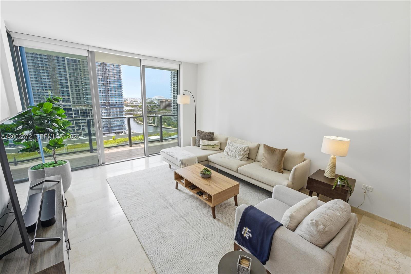 Reach at Brickell City Centre. 1-bedroom, 1.5-bath residence with 810 sqft of interior space and a deep terrace overlooking the river and skyline.Located on the 11th floor with west exposure, the unit captures steady natural light and sunset views while maintaining a more usable, comfortable height compared to higher floors.The layout is efficient and fully functional, with a proper living area that extends directly into the balcony, creating a strong indoor-outdoor connection. Clean lines and neutral finishes allow the space to feel open, bright, and easy to adapt.Interior features include marble flooring throughout, modern Italian cabinetry, quartz countertops, and an open kitchen with integrated island seating, complemented by high-end appliances including Sub-Zero refrigeration and a built-in wine cooler.The primary suite offers direct balcony access, walk-in closet, and a spacious bathroom, soaking tub, and glass-enclosed shower.Well maintained and move-in ready. No redesign needed, no wasted space.Reach is directly connected to Brickell City Centre, placing retail, dining, and daily conveniences immediately downstairs. Full-service amenities include a half-acre deck, resort-style pool, spa, fitness center, and social spaces.One assigned parking space.
