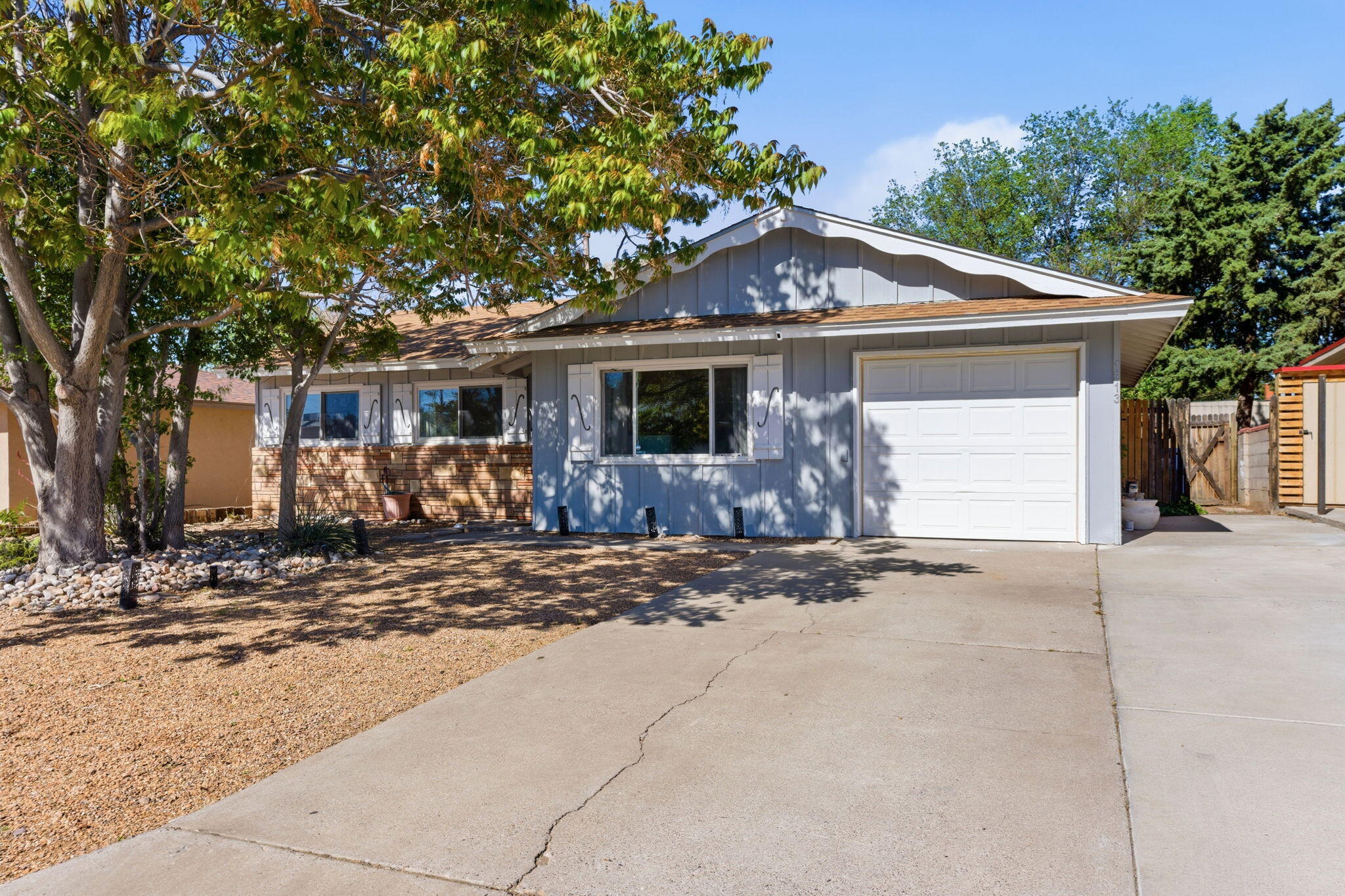 Move-in ready NE Heights home with great curb appeal! This 3-bed, 2 bath home has character!  Laminate floors highlight the living space- great eat in kitchen with updated cabinets and a spacious utility room for extra storage. Enjoy a large yard with a covered patio, shed & grass. Attached deep single car garage. Close to dining, shopping, and freeway access.