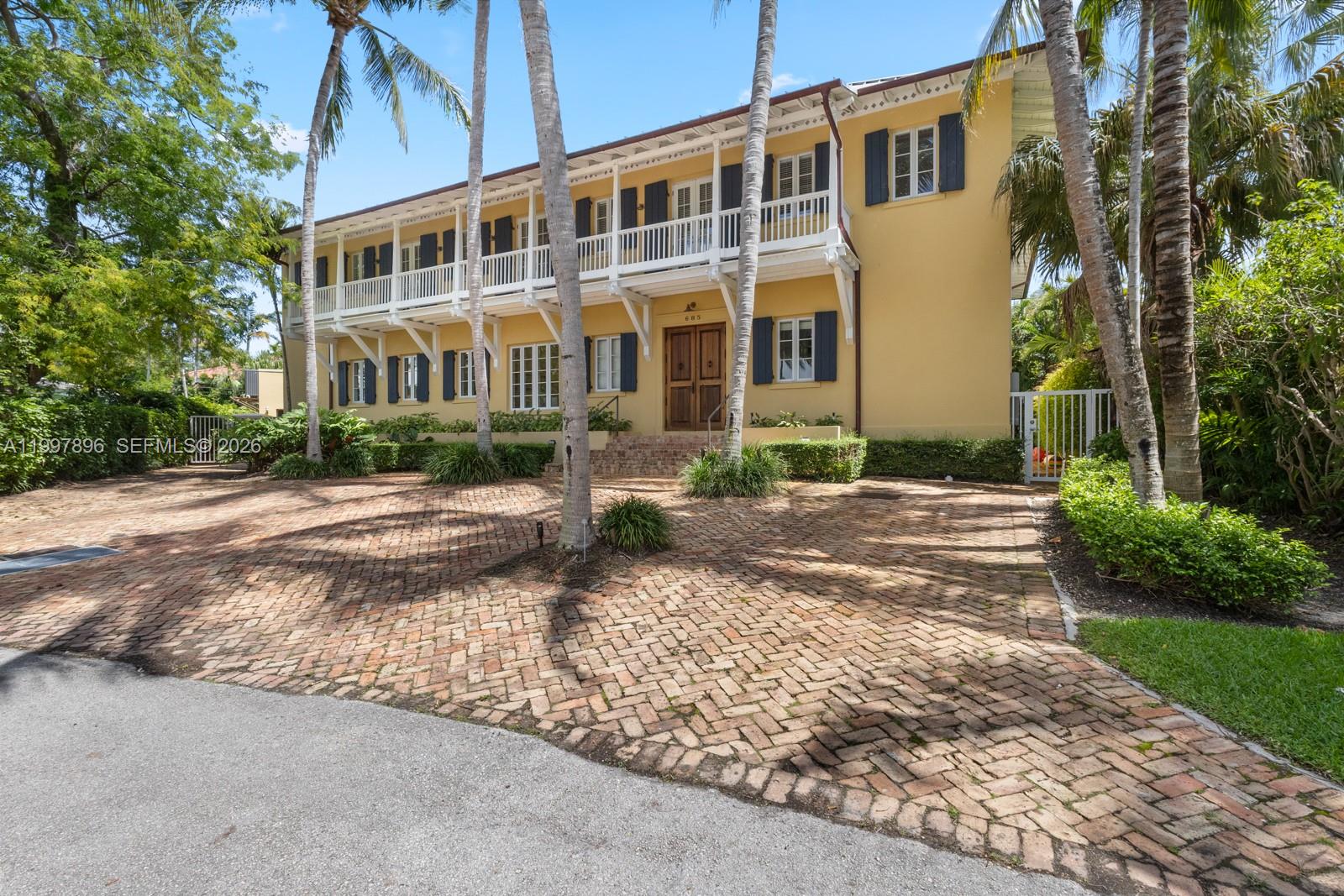 Timeless colonial-style residence, also known as Villa Rosa, set on a rare 12,200 sqft lot in the heart of Key Biscayne. Designed by renowned architect Cesar Molina, this 5-bedroom home is located on a very quiet, low-traffic street, offering privacy within a well-established, family-friendly neighborhood.The home features double balconies, bright interiors, and a functional indoor-outdoor layout with expansive covered terraces. The kitchen includes an island, Sub-Zero refrigerator, wine cooler, double ovens, and two dishwashers. The primary suite offers a private terrace, oversized walk-in closet with safe, and dual bathrooms with sauna.The spacious backyard includes a pool and generous green space. Additional features include maid’s quarters and construction that meets hurricane code requirements. Ideally located near beaches, parks, and top-rated schools, this is a rare opportunity to own a well-designed home on one of Key Biscayne’s most desirable streets.