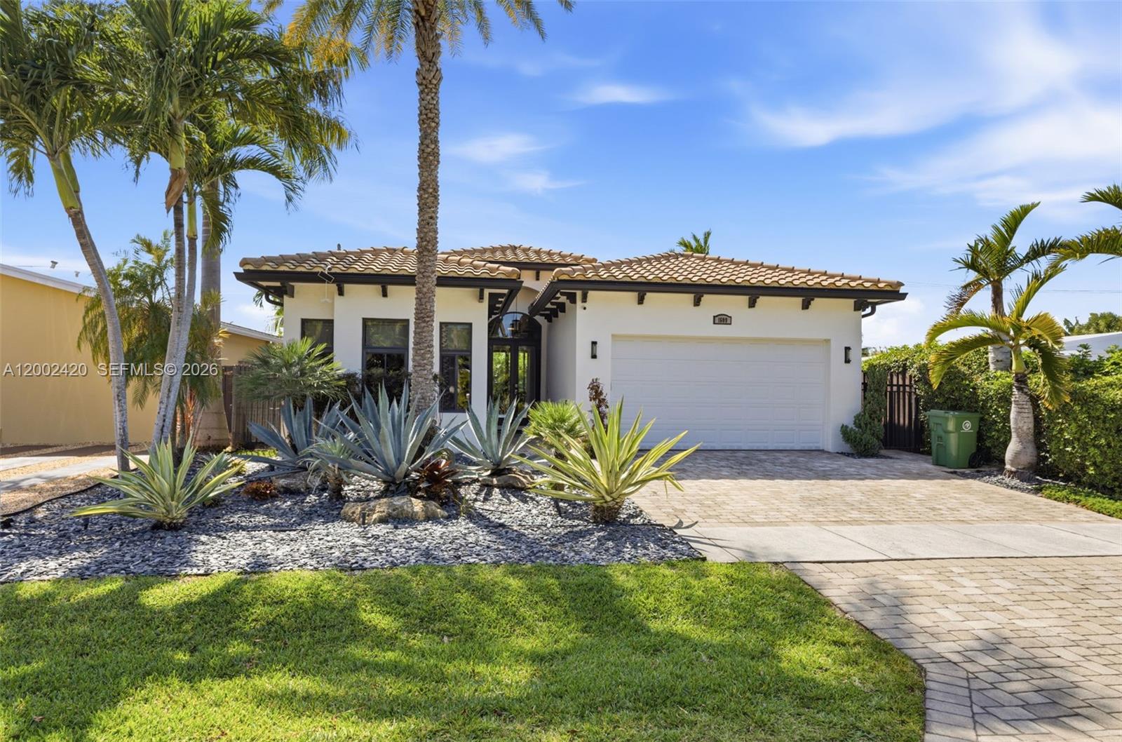 Experience modern South Florida living in this 2013-built 4BR/3.5BA executive pool home in highly sought-after Poinsettia Heights. With soaring 14'–15' ceilings and over 2,600 sq ft of refined living space, this residence offers a bright, open layout with walls of glass that seamlessly connect the indoors to the resort-style pool and patio. The chef’s kitchen features an induction cooktop, breakfast area, and generous cabinetry, flowing into spacious living and dining areas plus an additional family room. The expansive primary suite includes two walk-in closets and a spa-inspired bath with separate tub and shower.  A triple-split floor plan provides exceptional privacy: an en-suite second bedroom, two additional bedrooms, and a third full bath. Additional features include a large laundry room, powder room, 2-car garage, and abundant closet space.  Outside, lush landscaping surrounds the 28' pool, covered entertaining area, and outdoor shower. Tucked away in Poinsettia Heights yet minutes from Downtown, Las Olas, the beaches, and Wilton Manors, this property is a rare find.