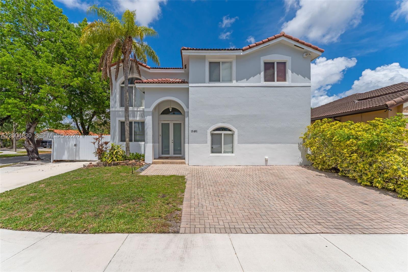 This 4-bedroom, 3-bath two-story home at 13891 SW 39th Ter offers 2,446 sq ft of living space on a corner lot with rare side space for a boat, RV, or additional parking, all in a convenient Miami location near shopping and dining.Welcome to a spacious and functional layout featuring a full bedroom and full bathroom on the first floor, ideal for guests or multi-generational living. The home showcases high ceilings in the formal living area, creating a bright and open feel from the moment you walk in.The updated high-end kitchen includes modern finishes and is complemented by LG washer and dryer, adding both style and convenience. Tile flooring throughout enhances durability and easy maintenance, while impact windows and doors provide security and energy efficiency.Upstairs, the oversized primary suite offers a large private retreat with a spacious bathroom featuring both a jet tub and separate shower. Step outside to an amazing covered terrace, perfect for entertaining, overlooking a fully paved concrete backyard with plenty of space to host and enjoy.With no HOA, this property offers flexibility and freedom. Located in Miami 33175, within walking distance to shopping centers and restaurants, this home delivers space, function, and lifestyle.