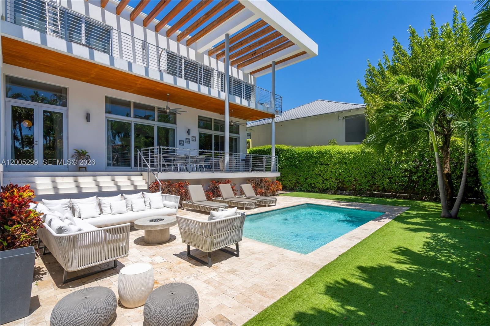 Situated on a unique 8,125 SF oversized lot, this modern 6-bedroom, 5-bathroom residence plus powder room offers a compelling combination of space, privacy, and strategic positioning in Key Biscayne. Built in 2017, the home is located at the end of a quiet street, with no direct front neighbor—an uncommon feature that enhances both privacy and curb appeal.With 3,964 SF of living area under A/C, the layout is thoughtfully designed for functionality and comfort. The home features 6 bedrooms, including 4 en-suite, plus 2 additional bedrooms connected by a Jack & Jill bathroom, offering flexibility for family living or guests. High ceilings, impact windows, and abundant natural light define the interiors. Marble flooring on the main level and hardwood floors upstairs add warmth and contrast to the clean, modern design.The open layout seamlessly connects indoor spaces to a spacious covered terrace and pool area, creating an ideal indoor-outdoor living experience. Electric blinds throughout provide convenience and effortless control of natural light, complemented by multiple upgrades that enhance both comfort and functionality throughout the home.Located just steps from one of Key Biscayne’s top-rated schools, this property offers scale, design, and a highly desirable location—an increasingly limited opportunity in today’s market. A thoughtfully designed residence that stands out for its scale, privacy, and positioning—rarely found in Key Biscayne.