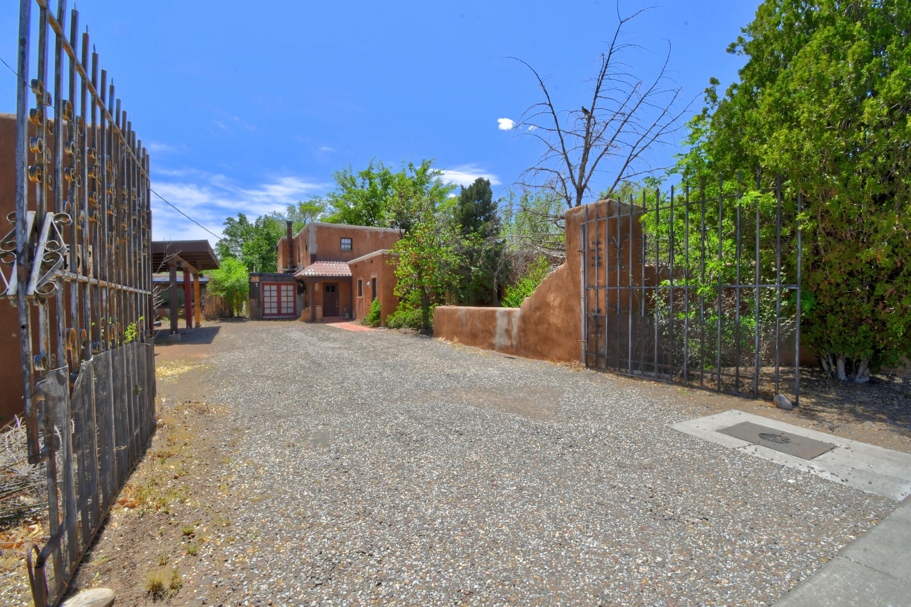 Another price improvement!!  What an opportunity! This property has endless possibilities to turn it into your vision, 1.22 acres with water rights access in SW corner of the lot, part adobe, brick floors, radiant heat, character all around needing creativity, or tear down and build your own dream home or possibly subdivide and build smaller custom homes. Located off Rio Grande down the road from the Bosque Trail and not far from Old Town, the Nature Center, shops and restaurants.  Don't miss this one.  Schedule a showing to check out what could become a great investment.