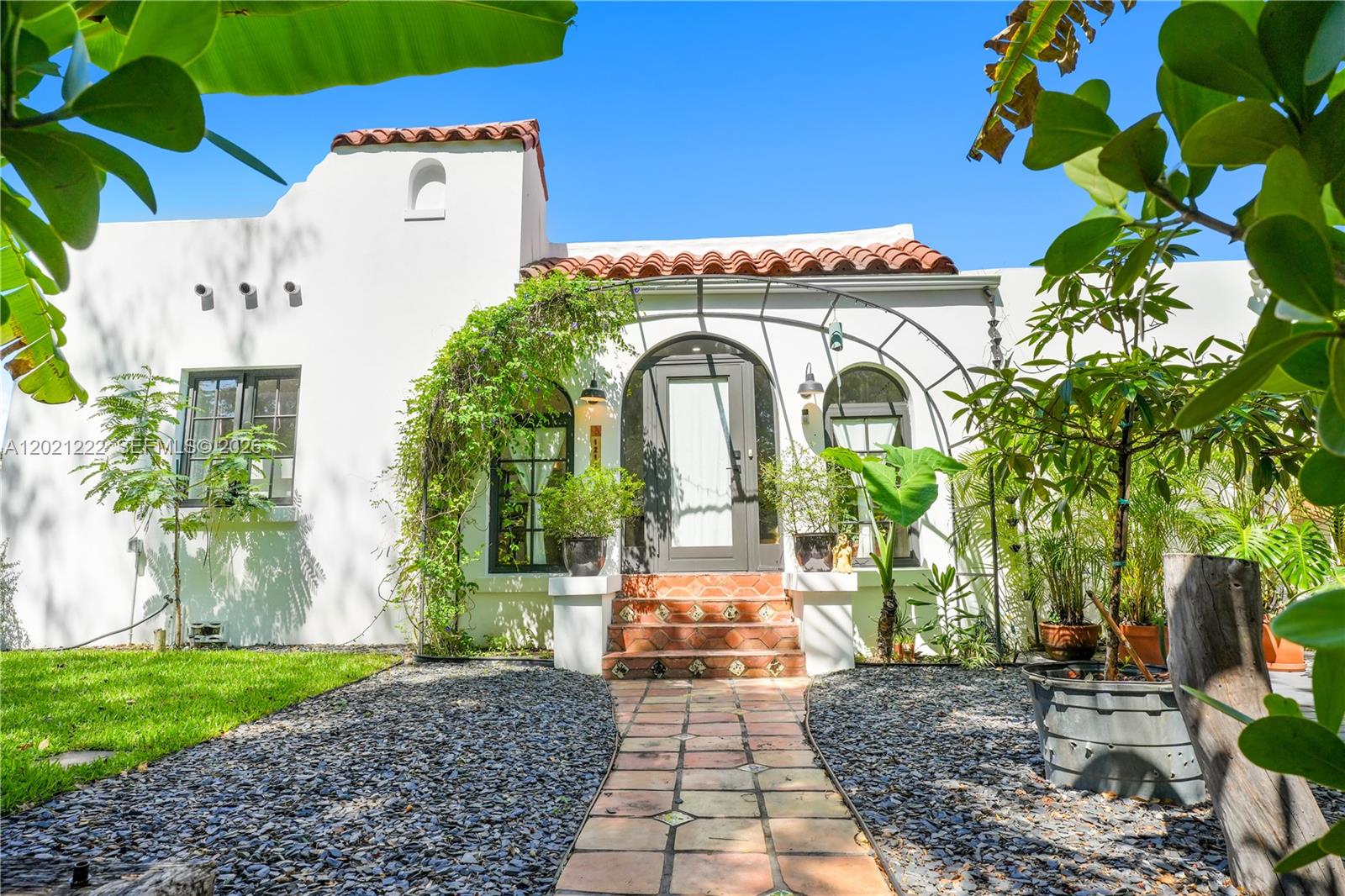 A Reimagined 1925 Legacy Estate. Welcome to 1214 Capri Street — the quintessential Coral Gables residence. Built in the traditional Spanish Mediterranean style, this 1925 estate reflects the timeless architecture envisioned at the city's inception. Set on an oversized 7,500 SF lot in the heart of the Granada Historic District, the property features a main house (3BD/2BA/1 half BA) and a fully appointed guest house (1BD/1BA), delivering 2,217 SF of refined living space surrounded by lush, mature landscaping. Extensively renovated between 2021–2025, highlights include a new primary suite, impact windows & French doors, wide-plank hardwood floors, designer porcelain tile baths, and a chef's kitchen with gas cooktop and coffee bar. The south-facing pool and composite deck bask in sunlight until sunset, surrounded by lush landscaping and a privacy wall. Shaded patio areas invite to lounge throughout the day. New smooth stucco exterior, repiped plumbing, new electrical panel, and new HVAC system in the main house. An on-site propane system fuels both the cooktop and water heater, keeping utility costs remarkably low.  Ideally situated just one block from the iconic Granada entrance and within walking distance of the Granada Golf Course — a tranquil sanctuary in one of South Florida's most storied neighborhoods. A true legacy property, lovingly reimagined.