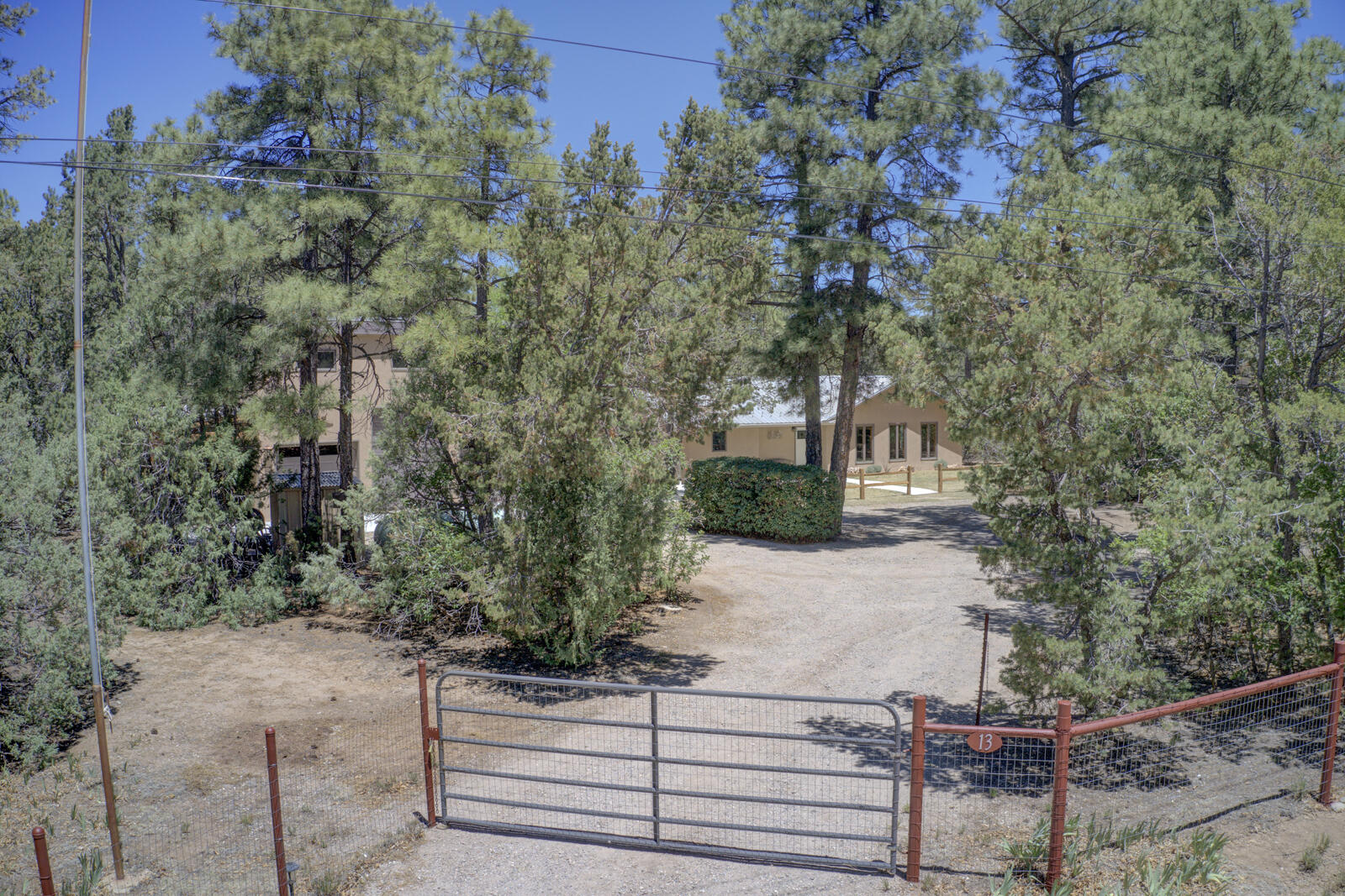 Welcome to your perfect mountain retreat! Nestled on 1.25 beautifully wooded acres just 20 minutes from Albuquerque, this meticulously maintained, ranch-style home offers the ultimate blend of peaceful country living and modern convenience. From the moment you arrive at thisfully fenced and gated property, you will feel the warmth and care that has gone into keeping both the interior and exterior in pristine, move-in-ready condition.Step inside to find a light-filled and welcoming 3-bedroom, 3-bathroom layout designed for ultimate comfort. Beautiful hardwood floors stretch underfoot, complemented by premiumAnderson wood double-pane windows and  that invite the natural beauty of the outdoors inside.Click on More