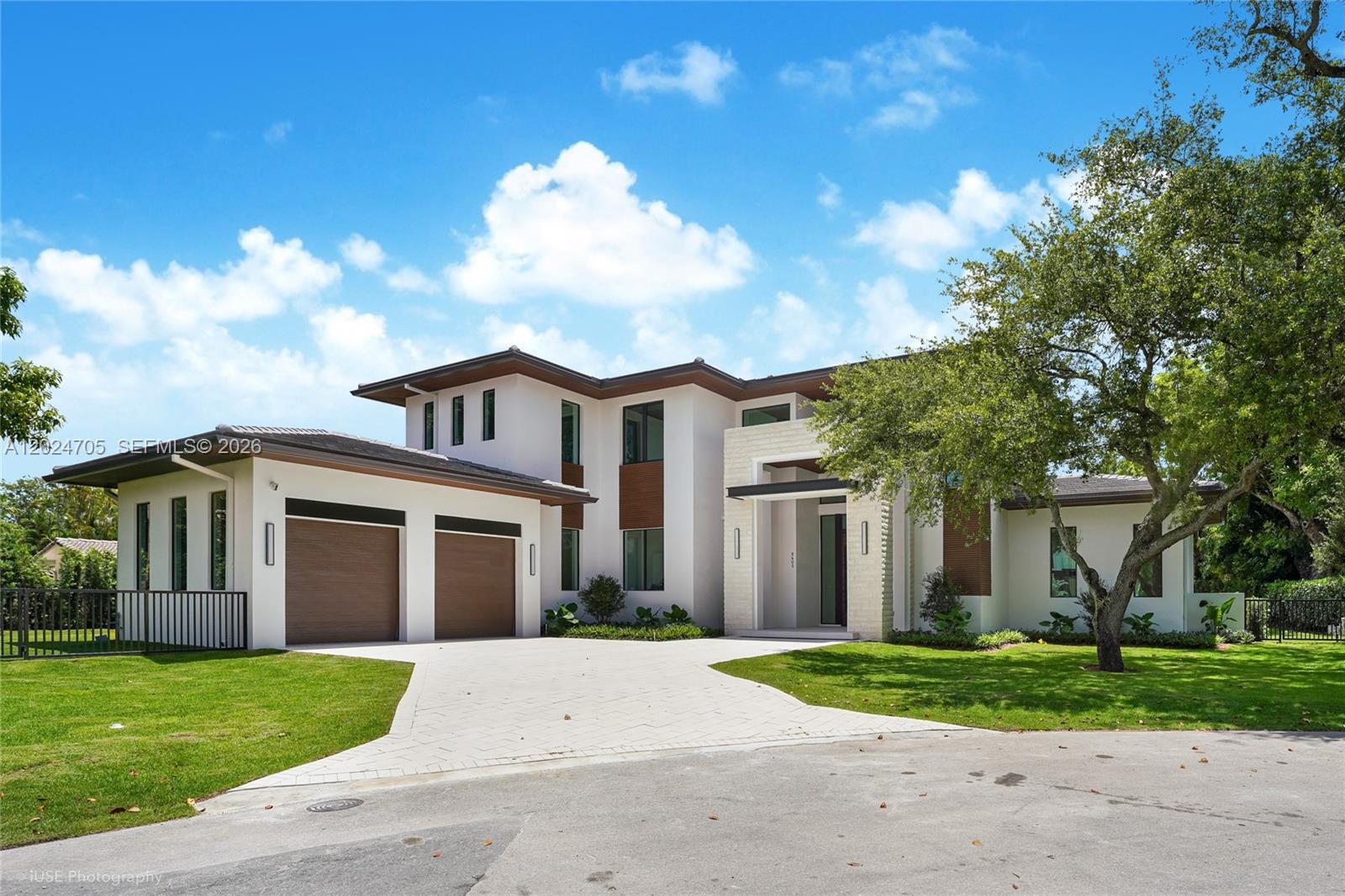 Tucked away at the end of a quiet cul-de-sac in the exclusive Coconut Palm Estates in North Pinecrest, this brand-new 6br/5.5ba, 6,806 total sq ft custom home by the renowned Pacheco Architecture team, features cabinetry and design by Italkraft, offering bespoke luxury with designer finishes.The smart home features a private elevator, two laundry rooms (upstairs/downstairs), and a spa-style steam room. The chef’s kitchen includes a butler’s pantry with premium Sub Zero/Wolf appliances. Outdoor living shines with a fully equipped, expansive outdoor kitchen featuring bar seating, dishwasher, ice maker, and more. The 40-foot saltwater pool system with separate jacuzzi and outdoor shower adds to the oasis.The primary suite boasts an expansive his/hers walk in closet as well as a private morning bar with a refrigerator. Walk-in closets by Italkraft throughout the homeAdditional features:  Energy-efficient low-emission windows, 4 AC units w/ smart thermostats, electric vehicle charger, generator ready, solar panel ready, Duravit smart toilets, 4K integrated security camera system, hardwired Cat6 network, epoxy garage, well water sprinkler system, indoor/outdoor speaker sound system