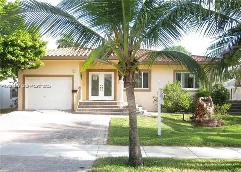 Beautifully maintained one-story residence in Hallandale Beach, ideally located east of US-1 and just minutes from the beach, Gulfstream Park, shopping, dining, houses of worship, hospitals, and major airports.  Built in 2008, this 4BR & 3 Bath home with garage offers a functional layout, quality construction, and excellent flexibility for a variety of living arrangements.The interior features spacious living areas, a split floor plan, walk-in closets, laminate wood flooring, and impact windows and doors. A separate guest or in-law area with private entrance and second kitchen adds valuable versatility for extended family, guests, or multigenerational living. An open rear porch and fenced yard complete the outdoor space