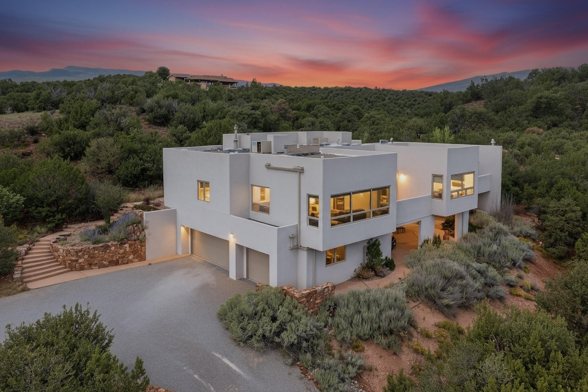 Extraordinary views. Exceptional care. Unmatched tranquility. Perched on more than 3 private acres in Paako, this meticulously maintained contemporary home captures some of the most breathtaking views in the East Mountains, stretching across the San Pedro, Ortiz, and Sangre de Cristo ranges. Expansive windows, artistic architectural details, and light-filled living spaces create a seamless connection to the landscape beyond. Thoughtful upgrades throughout and an architect-designed studio addition reflect years of investment and pride of ownership. A home where nature, privacy, and refinement exist in rare balance--an experience that simply cannot be appreciated from photos alone.