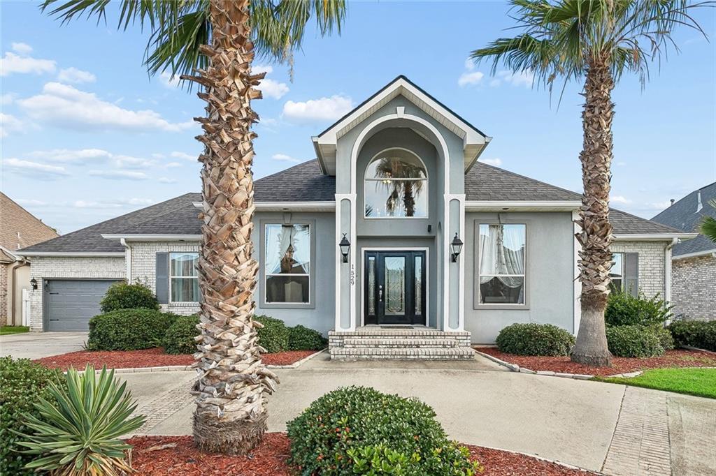 Waterfront living at its finest. This stunning Clipper Estates home is packed with thoughtful upgrades and designed for both everyday comfort and effortless entertaining. Step inside to soaring high ceilings, an open floor plan, and luxury vinyl waterproof flooring throughout. The living room anchors the main space with custom built-in shelving and an electric fireplace. The formal dining room adds elegance, while the kitchen delivers with a 5-burner stove, double ovens, refrigerator, granite countertops, and a granite island built for gathering. The primary suite is a sanctuary of its own featuring a tray ceiling, sitting area, electric fireplace, private door to the screened patio and backyard, a freestanding soaking tub, crystal chandelier, and double vanity. A bonus room above the garage, great for guests or an at-home gym. Situated on nearly half an acre, enjoy an 85-foot dock with vinyl bulkhead and a boathouse with hoist, plus direct water access for boating, fishing, and jet skiing. The pass-through garage provides easy backyard access for all your recreational equipment. A transferable home warranty with Old Republic is in place through May 2027, giving your buyer added peace of mind from day one. Just 5 minutes to Lake Pontchartrain. This one was built to impress. Come see it for yourself.