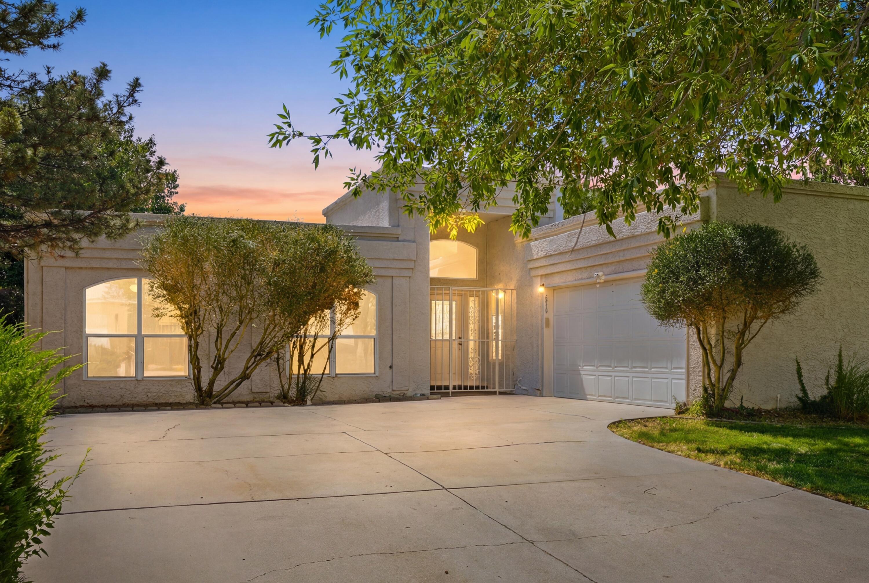 Far Northeast Heights Heritage Hills single-level home with refrigerated air, main-level primary suite, corner lot, walled backyard, 2-car garage, storage shed, and flexible office/4-bedroom layout. High ceilings and natural light bring an easy flow through the living, dining, breakfast nook, and kitchen, where a gas range and decorative fireplace create a warm focal point. The primary suite offers dual vanities, garden tub, separate walk-in shower, and walk-in closet. A front office, powder bath, laundry room, and practical layout add versatility, while the walled yard creates a private outdoor setting. Near Heritage Hills Park, groceries, shopping, and restaurants.