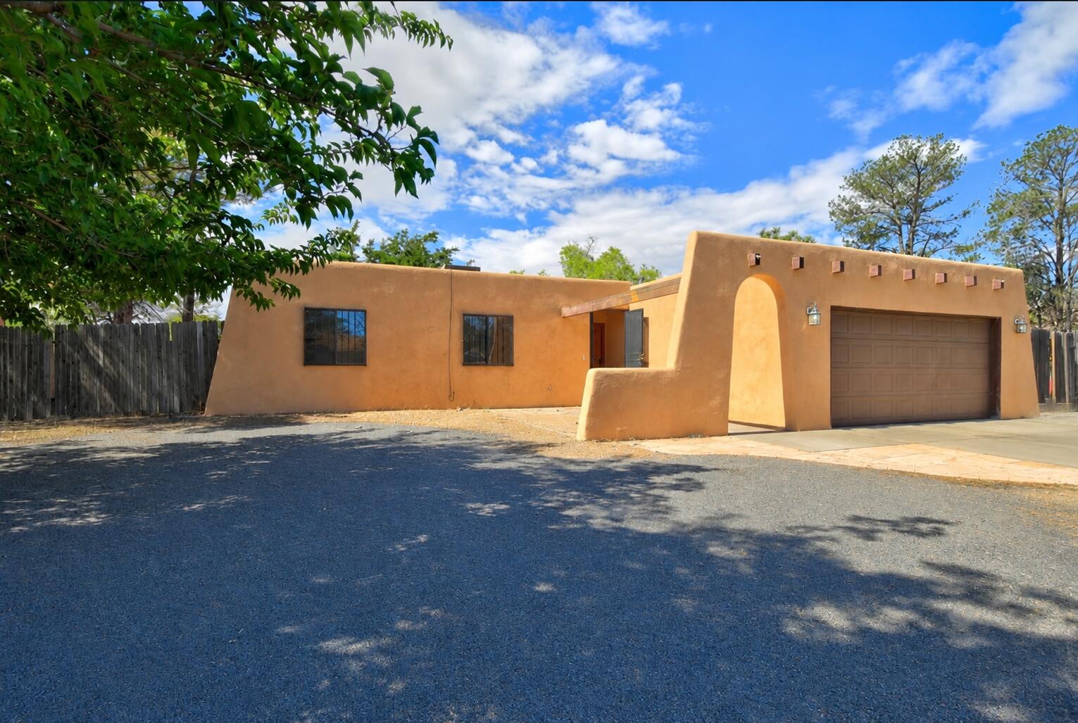 Instant Equity recent appraisal showed at $328,000. Charming Rio Rancho home situated on a spacious .26-acre lot, featuring mature trees and a pergola! Backyard access ideal for an RV, camper, boat, or additional vehicles. Inside, you'll find luxury wood-like vinyl flooring installed in 2023, updated light fixtures, granite countertops, and a warm living area highlighted by classic Saltillo tile and a cozy wood-burning fireplace. Recent mechanical updates include a new furnace (2021), evaporative cooler (2022), and refrigerator (2025), providing peace of mind for years to come. Complete with a 2-car garage and conveniently located near schools, shopping and restaurants. This inviting property offers comfort, character, and space both inside and out.