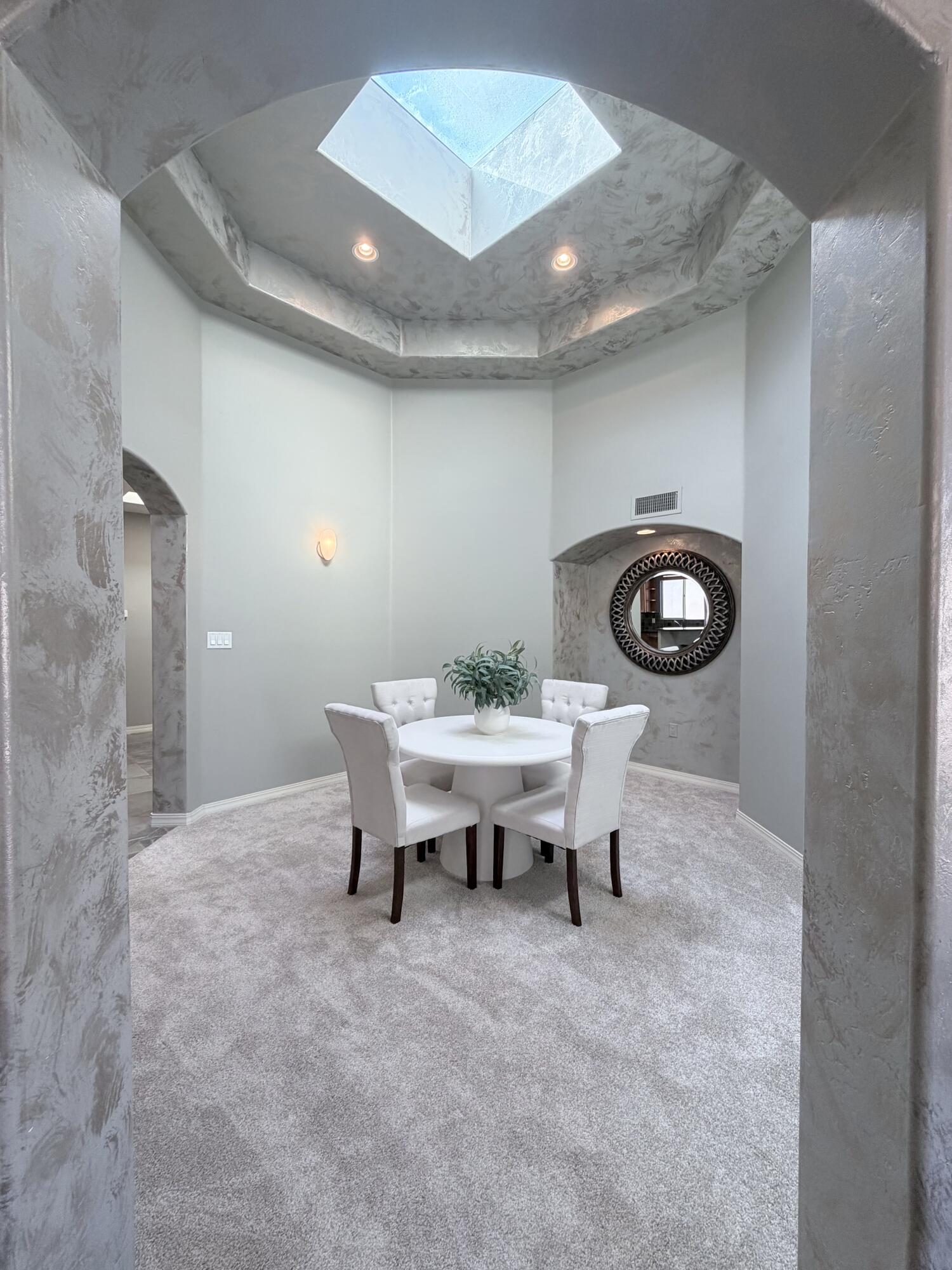Professionally staged and newly priced, this former builder's model in Vista Del Norte's exclusive gated enclave blends quality craftsmanship and timeless appeal. This beautifully appointed three-bedroom, two-bath residence features a primary suite separated from the secondary bedrooms, soaring ceilings, radiant heated floors, high-end cabinetry, skylights, two fireplaces, and a one-of-a-kind architecturally designed dining room that serves as a striking centerpiece for both everyday living and entertaining. Offering a low-maintenance backyard for the frequent traveler or busy homeowner, or a blank canvas for a personalized outdoor retreat. With the convenience of being in the center of the city, the home backs to a premier balloon landing site, offering unforgettable views!
