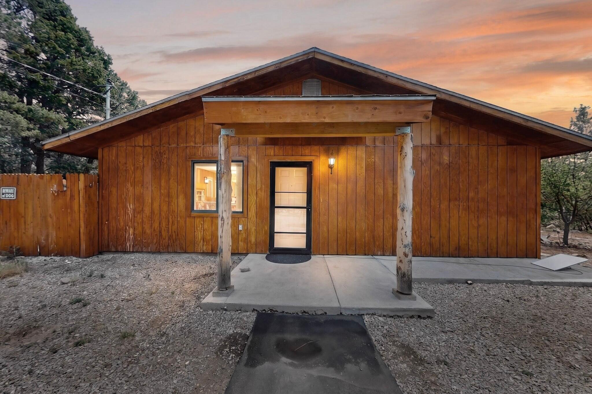 Cabin charm meets everyday convenience in this Tijeras gem! Set on .79 acres for privacy, this home features warm brick flooring and a pellet stove for cozy winter evenings. All appliances, including washer and dryer, convey. A workshop and side yard shed offer great flexibility for projects and storage, and newly installed rain gutters add peace of mind. Just 20 minutes to town, enjoy the best of mountain living with an easy commute. This is the retreat you've been waiting for!