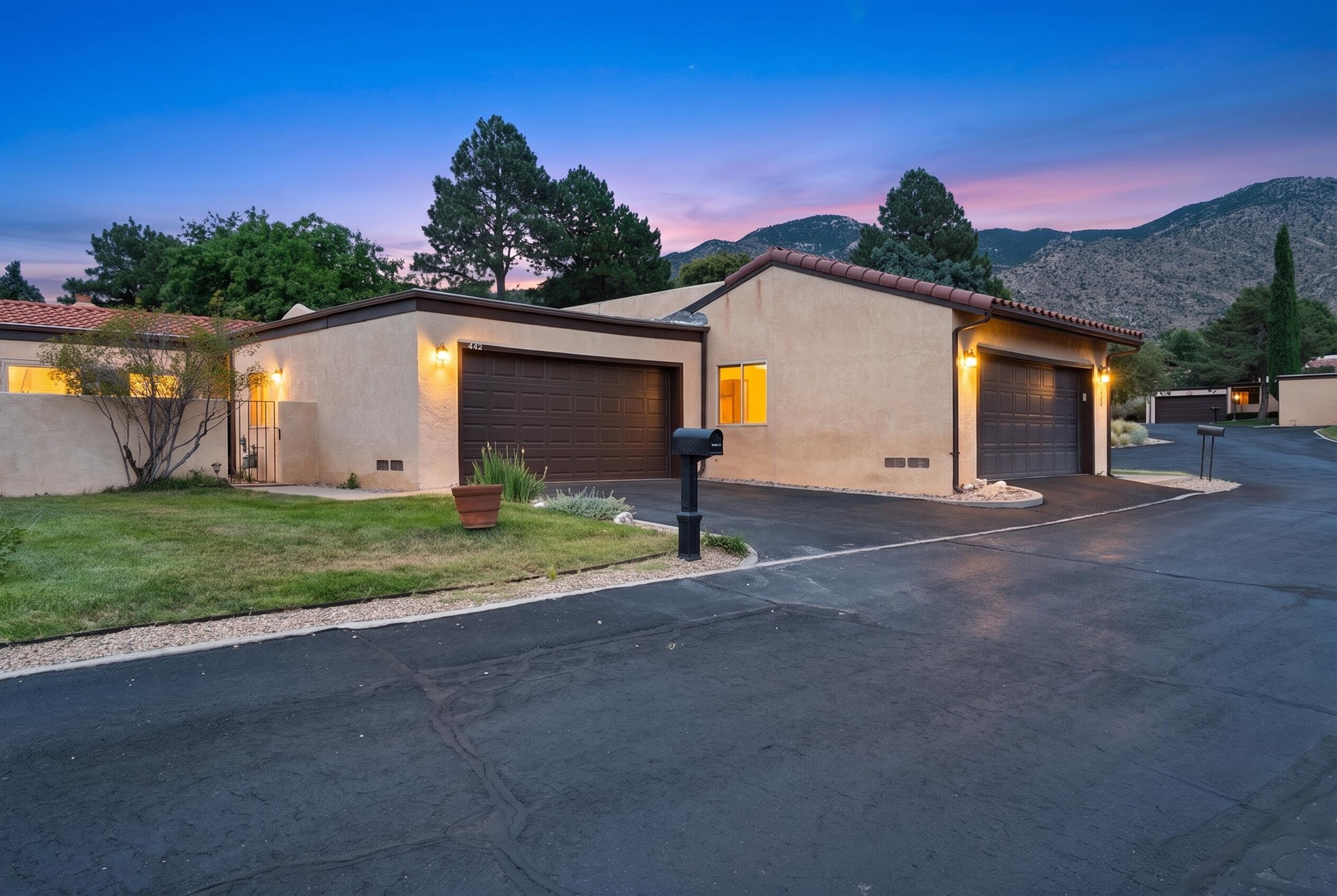 Welcome to this well-maintained townhome in  Albuquerque's  Foothills. Thoughtfully designed featuring 2 bedrooms, 2 bathrooms, and 2-car garage with cabinets and shelving.Thoughtful floor plan flows from entry to  kitchen and dining/formal rooms leading tospacious living areas. A two-sided fireplace creates a natural connection between the living and family rooms,. Sliding glass doors provide easy access to the backyard patio viewing the common area green space beyond.Enjoy refrigerated air, a tankless water heater, and a low-maintenance lifestyle in a peaceful setting. Conveniently located just minutes from grocery stores, fitness centers, restaurants, parks, and the Sandia Foothills and easy access to the Tramway multi-use trail.