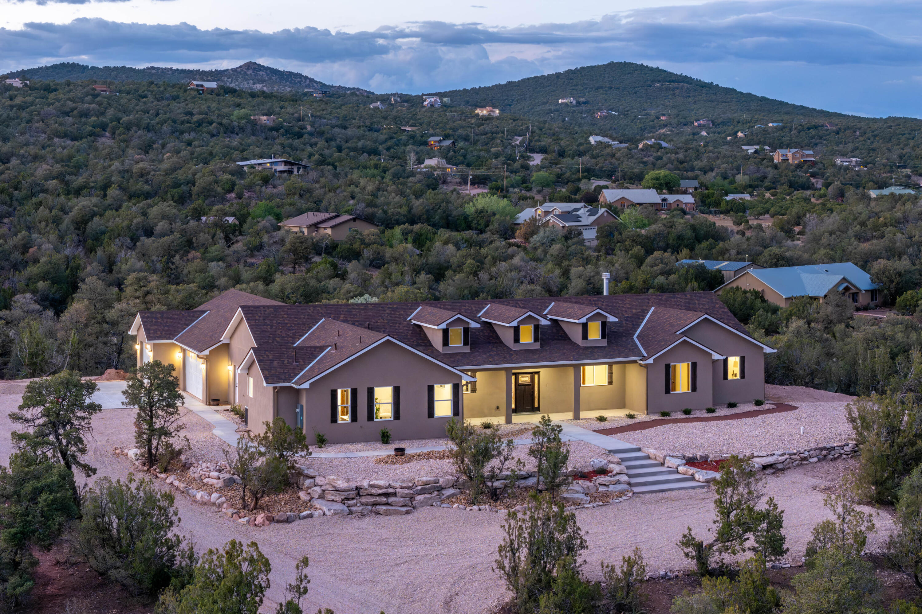 Positioned in a serene, wildlife-rich setting, with quintessential views! This custom-built residence delivers a rare blend of luxury craftsmanship, cutting-edge efficiency, and architectural presence-- From the moment you enter, the home makes a statement. Premium 22-mil luxury vinyl flooring (top-tier grade, 20-year warranty) flows throughout, complemented by knotty alder doors, custom trim, and elevated finishes at every turn. Built with 2x8 construction, R60 ceiling insulation, and R30 walls, this home exceeds standard building practices--offering exceptional energy efficiency and long-term value. The chef's kitchen is both functional and striking, featuring expansive granite surfaces, soft close cabinetry, designer tile backsplash, and a generous butler's pantry enhances storage and entertaining capability.The open-concept living space is designed to impress, with exposed wood beam ceilings, a custom stacked-stone wood-burning fireplace with blower, and oversized windows anchored by a dramatic glass door--framing the private backyard where deer are a regular presence.The primary suite delivers a true luxury retreat: a spacious walk-in closet with custom built-ins, and a spa-caliber bath complete with a soaking tub, designer fixtures, and a custom-tiled walk-in shower with dual heads--crafted for both relaxation and impact.A thoughtfully designed split floor plan includes a private junior suite with its own en-suite bath, ideal for guests or multigenerational living. The mudroom and laundry area are strategically positioned for daily convenience without sacrificing design.Car collectors and outdoor enthusiasts will appreciate the fully finished 1,356 sq. ft. garage, including an extended third bay for oversized vehicles, equipment, or workshop space.High-performance systems include a 98% efficiency furnace, Marlarkey architectural shingles (speed rating of 110 mph) and a tankless water heater with recirculating pump--ensuring comfort, efficiency, and modern reliability. NO HOA!