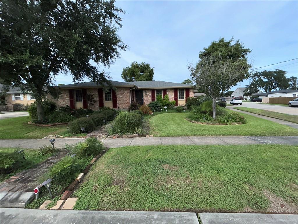 Stop Looking! This home is waiting for your personal touch.  Very well maintained home on a gorgeous corner lot.  Landscaping bones are there with lighting included.  Inside you will have lots of space for entertaining with 2 living rooms.  There is also an Extra room off the kitchen that is multi purpose. The Galley kitchen with 2 ovens is a chefs dream.   You can have it all with this property.  The covered outside patio is great for parties no matter what this Louisiana weather brings.