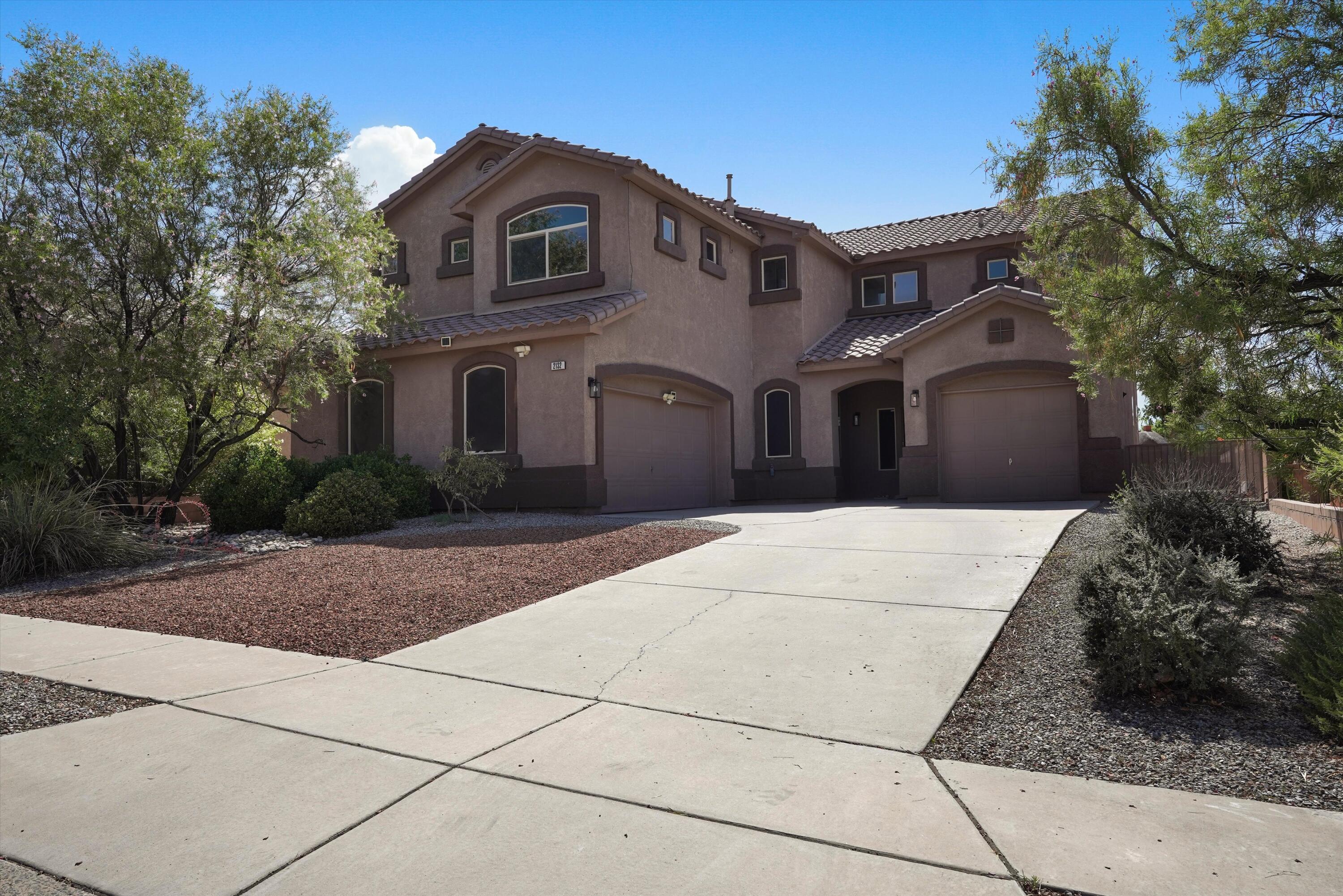 Spacious 5 bedroom, 3 bathroom home in the desirable Cabezon community featuring multiple living areas, soaring cathedral ceilings, wood, tile and carpet flooring, and a welcoming gas-log fireplace. The well-appointed kitchen offers a center island, breakfast nook, built-in bar, pantry and stainless appliances, while formal and casual dining spaces provide plenty of room for entertaining. The upstairs primary suite includes a walk-in closet and full bath with double sinks, garden tub, separate shower and private water closet. Enjoy outdoor living from the balcony or covered patio overlooking the landscaped, walled backyard with grass, automatic sprinklers, scenic views and a gas stub for grilling.