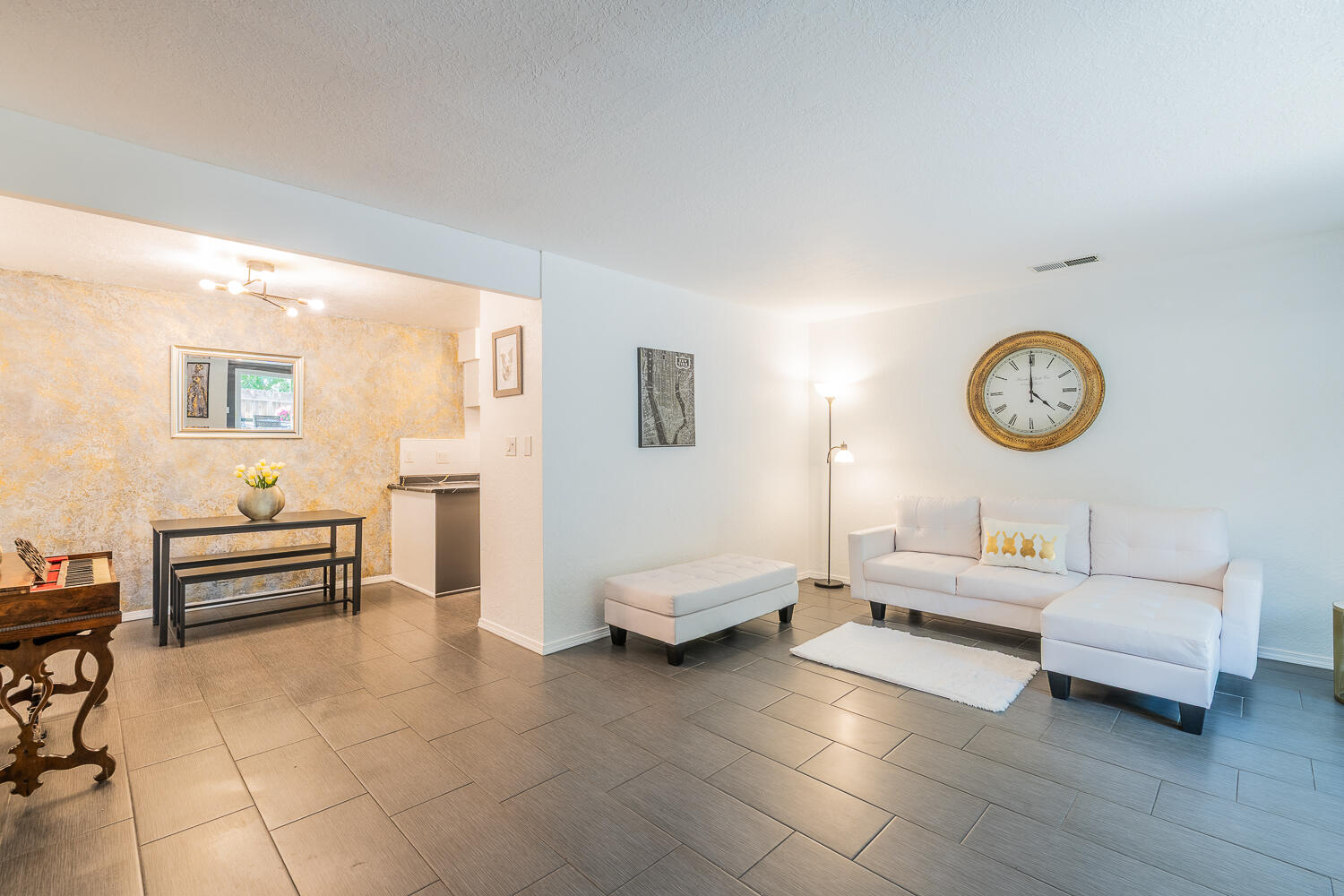 Take a look at this beautiful, contemporary 3 bedroom, 3 bath completely reimagined condo with designer finishes right at the base of the Sandia  Foothills. Gorgeous location just steps away from the Piedra Lisa Canyon Loop trail with 3 neighborhood parks within a half mile. All the big ticket mechanicals and cosmetic updates have been done for you! New carpet, paint, lighting, kitchen countertops, sink and stove 7/26. New central air, furnace, washer and dryer in 2024 and a new roof, garbage disposal and water heater installed in 2021. Newer doors and windows throughout. Lovely green surrounds your patio with mt. views from each of the upstairs bedrooms. Enjoy your living room fireplace on those crisp winter nights! Downstairs is all tile along with an updated 1/2 bath. HOA covers water, sewer, trash, exterior (including roof)  and common area maintenance. A one car garage with generous additional guest parking and all appliances are included. Perfect for roommate set-up, retirees, starter home or investors. A turnkey property in one of Albuquerque's premier locations!
