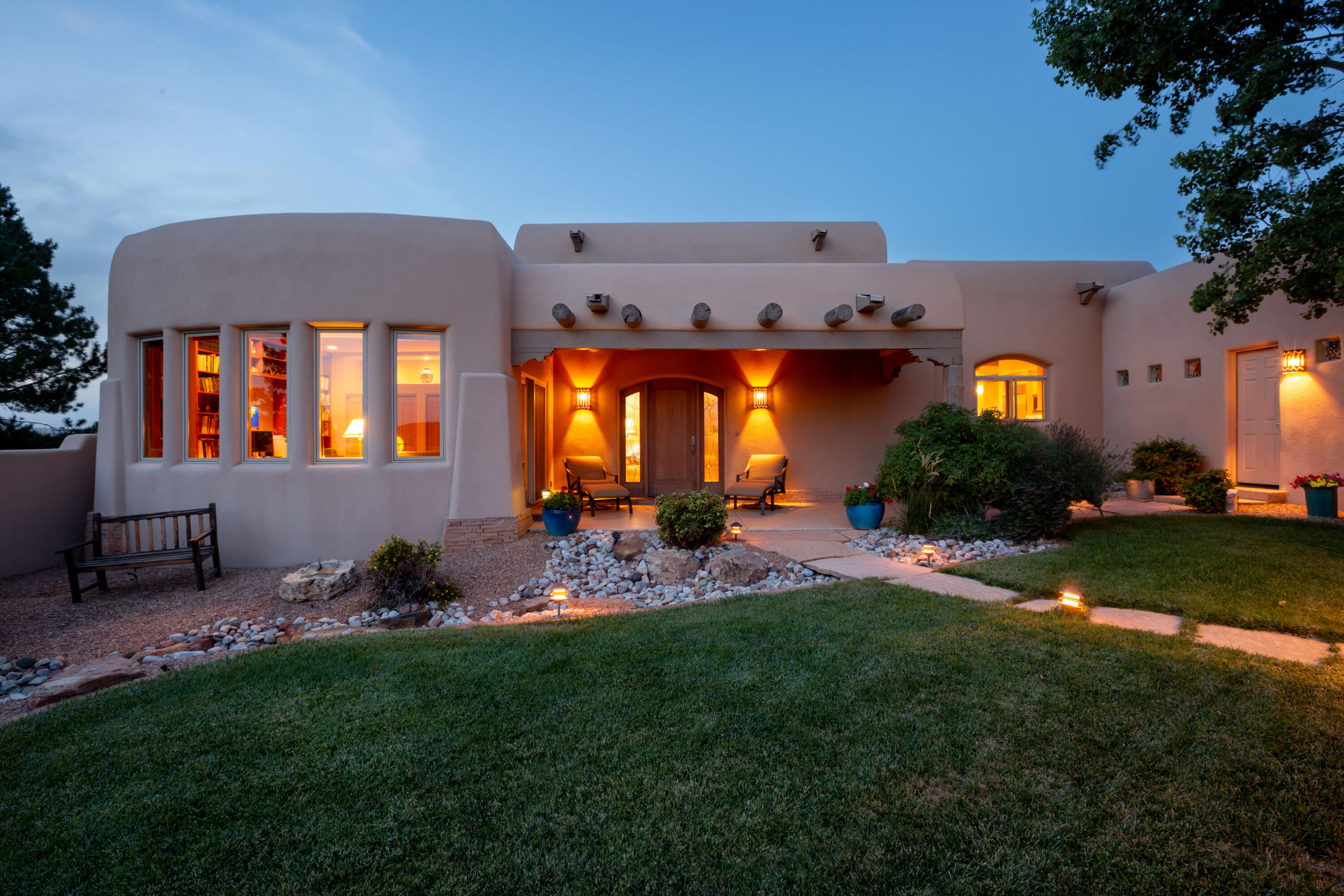 Open house Sun 8/2 1-3pm. HIGH DESERT! Welcome home to this exceptional custom Kokopelli 4-bedroom, 3-bath residence backing to unobstructed, breathtaking VIEWS of the Sandia Mountains! The inviting great room and open floor plan showcase spectacular VIEWS, soaring beamed ceilings, handcrafted posts and latillas, and expansive windows that flood the home with natural light. The chef's kitchen is beautifully appointed with quartz countertops, double ovens, a 6-burner gas cooktop, and a Sub-Zero refrigerator. The private primary suite with direct outdoor access is a true retreat, featuring a spa-inspired ensuite bath with separated vanities & dressing areas, a soaking tub, and a generous walk-in closet. Three additional spacious bedrooms provide flexibility for family, guests, home office or media room. Step outside to the beautifully designed outdoor living area, complete with a cozy fireplace and built-in grill - perfect for entertaining while taking in stunning Sandia Mountain sunrises and vibrant New Mexico sunsets. Additional highlights include a spacious 3-car garage with third bay ideal for a workshop with custom shelving, storage, and mini split, additional mini split units in media room & primary bedroom, seller-owned solar, in-floor radiant heat, water softener and purification system, hardwired security system, whole-house sound system, and so much more! A truly exceptional home!