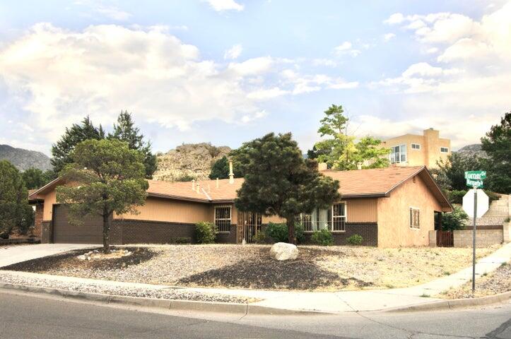 Great home in Foothills of the Sandia Mountains!  This single level, 4 Bed/ 2 Bath home, features an attractive open floor plan with formal living room and dining room, and a kitchen w/granite counters, stainless appliances and maple cabinets.  Newer refrigerated air and heat unit.  This Corner lot property has a fenced  back yard with a mature Pear tree and possible RV parking.  Great location near hiking and biking as well a close proximity to I-40, Sandia Labs, and Kirkland AFB.  Truly a Must See Property!
