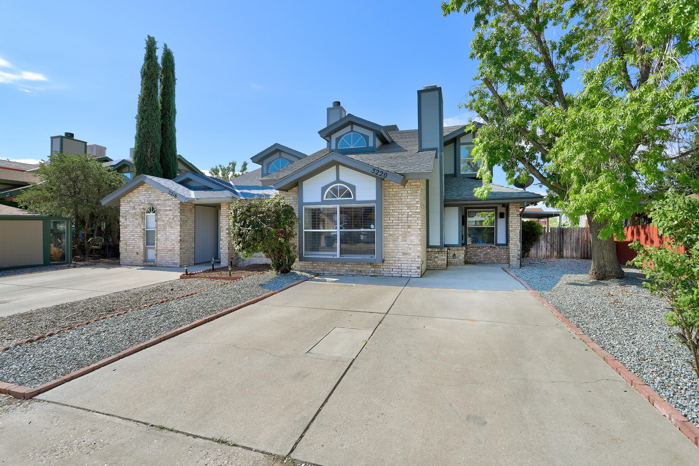 This thoroughly updated home combines turn-key convenience with a premium location backing directly to open space and a peaceful walking trail. From the handsome brick facade to the fully refreshed interior, this property is ready for you to move right in and enjoy. Step inside to discover a bright, open-concept floor plan highlighted by a soaring vaulted ceiling in the living room and a cozy wood-burning fireplace. The chef-ready kitchen boasts brand new solid-surface granite countertops, a new stainless steel gas stove, a matching microwave, and a new dishwasher.Every inch of the interior shines with fresh paint, updated lighting, and modernized bathrooms. Durable, stylish new Luxury Vinyl Plank (LVP) flooring flows through the main living spaces, while plush new carpet keeps the bedrooms comfortable.The highly desirable layout features a convenient main-level primary bedroom for ultimate privacy. Upstairs, you will find two additional spacious bedrooms and a versatile small loft space--perfect for a quiet reading nook or a dedicated home office.The property truly shines with its premium lot and excellent exterior storage. Relax under your covered back patio, which includes a highly convenient, built-in storage room. Out in the fenced yard, you will find an additional detached storage shed. Best of all, the lot backs directly to scenic open space, with a paved walking path situated just beyond your rear fence line for ultimate privacy and neighborhood connectivity.