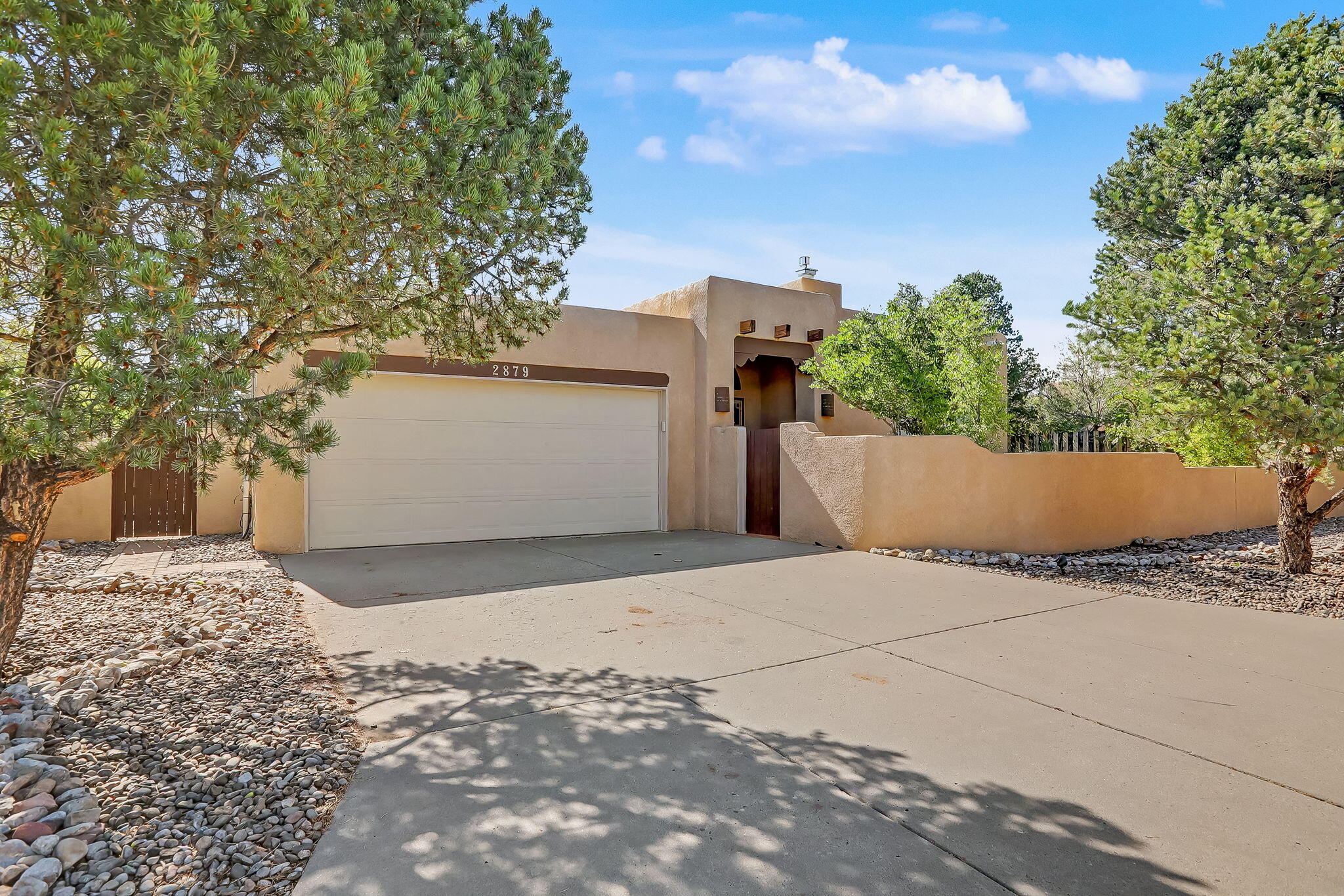 Views! Sandia Heights West!Brushwood One Level, Custom Contemporary SW Style Retreat on a Peaceful Panoramic, Sandia Mountain View Lot. Breathtaking Views from the front court patio and from inside in the greatroom and living areas. Views from  open and covered patios .  2 private entertainers decks off living spaces . 3 spacious bedrooms w/view windows & easy bath access . Secluded office. Private/separated PBR bedroom retreat w/outdoor/patio access & breathtaking vistas plus a private bath. 2 full baths. Spacious greatroom w/raised/beam ceilings & magnificent mountain views, elegant formal dining, eat in updated country kitchen with solid surface counters  SS appliances, tile floors. Service room & oversized 2 car garage w/abundant storage space Updates include updated tile flooring, lighting, appliances . W features include raised beam ceilings, nichos, santa fe walls, kiva fireplace with banco .The owners lovingly cared for the outdoor plants and flowers, garden & private courtyard ! Many updates include a spacious  kitchen with custom cabinets, solid countertops and stainless appliances, tile  flooring. Gracious open floor plan with beamed ceiling and sweeping views from the spacious great room. Large owner suite with private bath  Backyard features include  2 patio areas,  raised beds  fruit trees.more