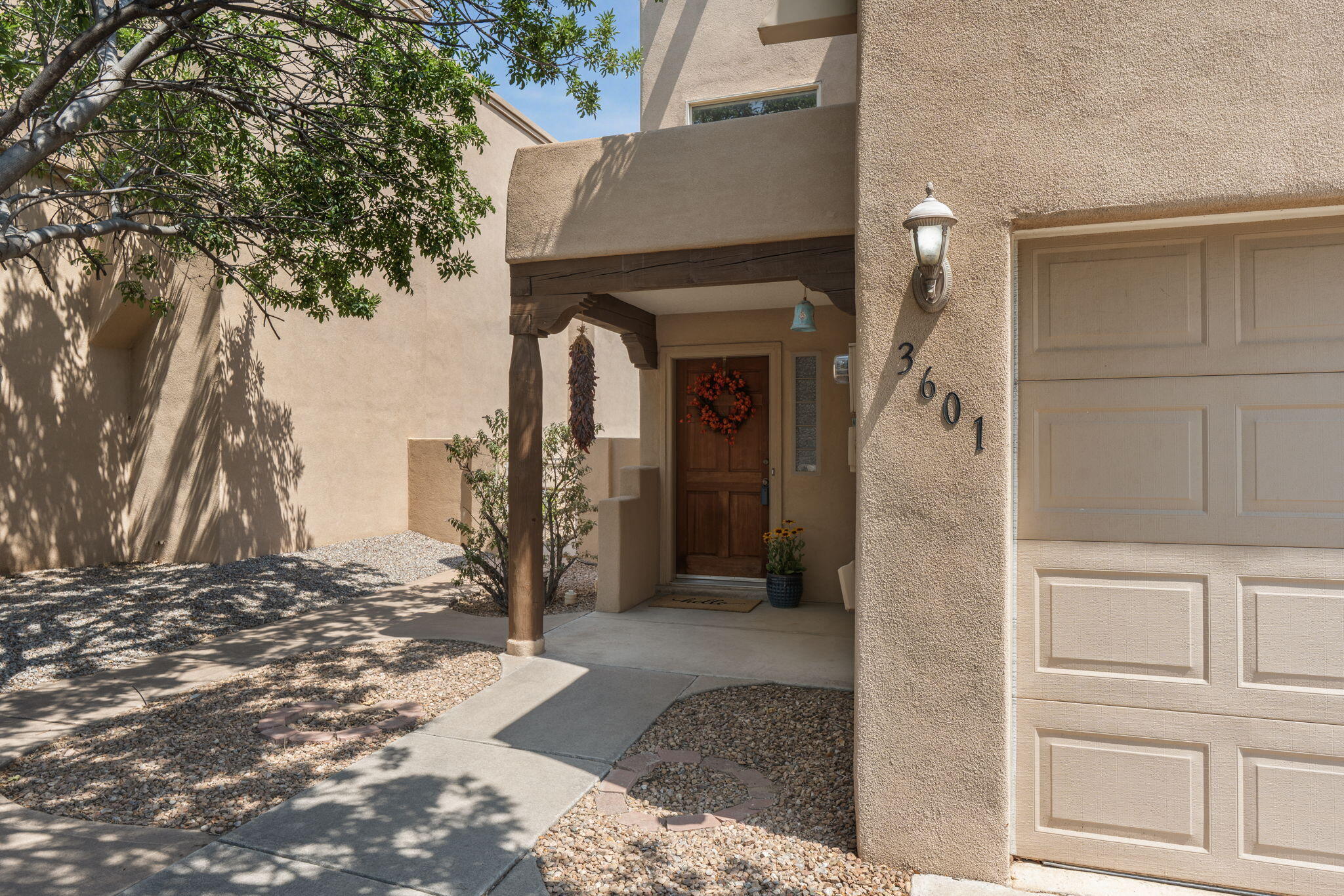 Fantastic home in a gated neighborhood which backs to the Rio Grande Bosque with neighborhood gate access to the Paseo del Bosque Trail. Southwest design elements, tongue-and-groove ceilings, and a living room fireplace give the interior a distinct New Mexico character. The open floorplan connects the main living spaces, while two upstairs bedrooms and a large deck off the primary suite add flexibility and outdoor space. A landscaped backyard and generous garage storage round out the property. Near M'Tucci's, Albertsons, dining and shops, with quick access to I-40 and Montano Rd.