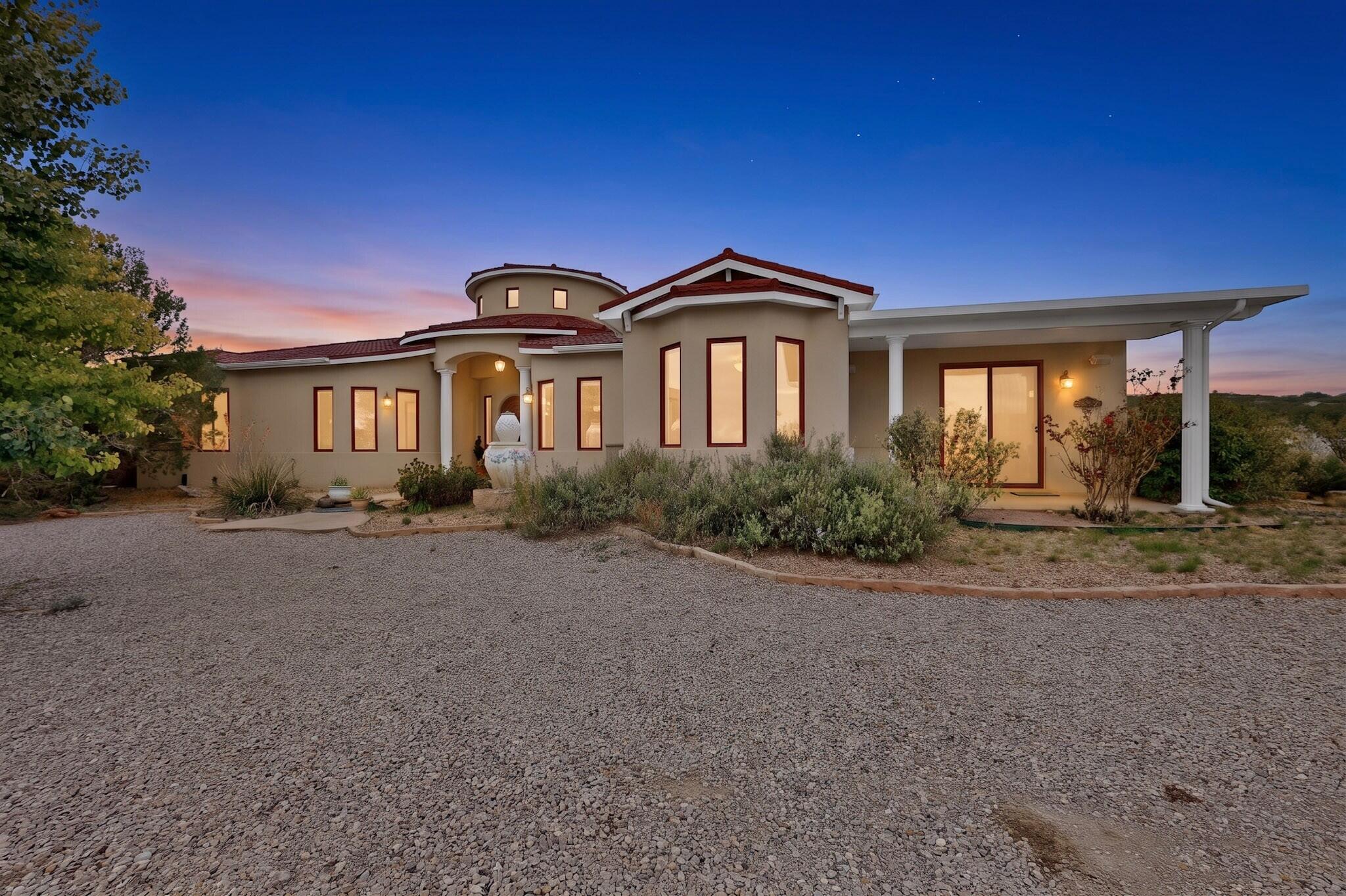Welcome to 7 Stonebrook Court in Tijeras, NM, a beautiful custom home built in 2007 by Homes by New Vistas and situated on over 1 acre. This spacious home features 4 bedrooms, 2.5 bathrooms, soaring ceilings in the main living area, and an oversized 2-car garage. The well-designed floor plan includes two gas fireplaces, one in the alcove off of the kitchen, a formal dining room, breakfast nook, LVT and ceramic tile throughout the home. The home has radiant heat and two refrigerated air units. The gourmet kitchen features a large JennAir refrigerator, a Samsung double oven, and an electric cooktop with downdraft venting. The Butler's pantry off of the dining room has a convenient second dish washer and room for an additional refrigerator. The primary suite has an en suite with a jetted bathtub and large walk-in shower, it also has two walk-in closets, while two additional bedrooms share a convenient Jack-and-Jill bathroom. A major advantage is the community water system, eliminating the concerns and maintenance that can come with a private well. With its custom construction, generous living spaces, large lot, and desirable Tijeras setting, this is an exceptional East Mountain property with plenty of room to enjoy both the home and the outdoors, with mature fruit trees and grapes vines, and a greenhouse with the convenience of water and electricity. The mature landscaping surrounding the home features an automatic irrigation system.