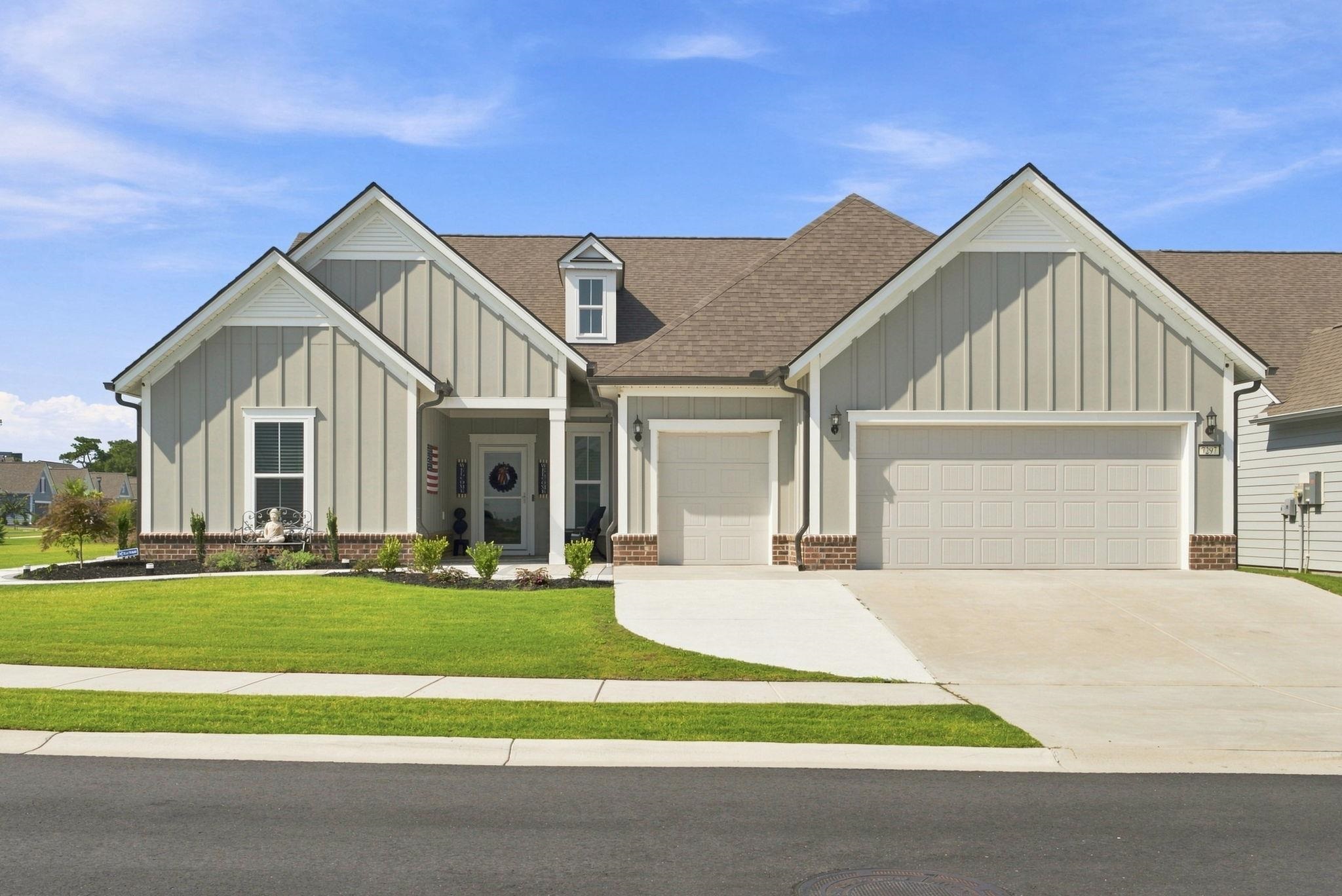 Welcome to 7297 Sarteano Drive at Del Webb at Grande Dunes—where exceptional craftsmanship, sophisticated upgrades, and resort-style living come together in one extraordinary home. Located in Myrtle Beach’s premier 55+ active-adult community, this remarkable 2023-built Dunwoody Way offers approximately 4,080 heated square feet of beautifully designed living space, with four bedrooms, four full bathrooms, a dedicated office, and multiple versatile living and entertainment spaces. Situated on one of the largest corner homesites in the community, this residence combines impressive curb appeal with an extraordinary level of interior customization. From the moment you arrive, the vertical panel siding, brick accents, and meticulously designed exterior create an inviting first impression. Step inside and discover a home where virtually every detail has been thoughtfully enhanced to maximize comfort, functionality, storage, and style. At the heart of the home is a stunning gourmet kitchen featuring an expansive quartz island, stainless-steel appliances, walk-in pantry, abundant cabinetry, and generous workspace—perfect for both everyday living and entertaining. Additional cabinetry has been thoughtfully added to create even more storage while enhancing the kitchen’s symmetry and design. The spacious open-concept living area is anchored by a contemporary fireplace, creating a warm and sophisticated focal point. Throughout the home, you’ll find high-quality Artisan hardwood-look LVP flooring, Craftsman-style trim molding, Minka ceiling fans, upgraded lighting, and custom finishes that elevate the overall aesthetic. The luxurious owner’s suite features a tray ceiling, beautifully appointed ensuite bath, and an expansive walk-in closet with professional organization. A second first-floor suite provides an ideal retreat for guests or family members. The main level also includes a third bedroom, additional full bathroom, dedicated laundry room, and convenient drop zone. The living spaces extend effortlessly outdoors to the enclosed screened patio, accessible through either the sunroom or entertainment area—creating the perfect setting for morning coffee, evening relaxation, or entertaining guests while enjoying the coastal Carolina lifestyle. The oversized 2½-car garage is another standout feature. The garage floor has been professionally epoxied and the space is equipped with its own mini-split HVAC system for year-round comfort. A staircase leads to an extraordinary finished storage area above the garage, complete with flooring, dedicated mini-split HVAC, and abundant space for storage, hobbies, a workshop, or other personal uses. Upstairs, the home continues to impress with a professionally designed media/entertainment room, a dedicated storage room for audio equipment, a fourth bedroom, and a full bathroom. Throughout the residence, the owners have creatively utilized originally unused areas and optimized closets and storage spaces to make this home exceptionally functional. The extensive list of upgrades goes well beyond aesthetics. A whole-house water softener provides enhanced water quality while helping protect appliances and plumbing. The HVAC system has been carefully optimized with register vents and dampers designed to balance airflow throughout the home. Additional efficiency features include a high-efficiency tankless water heater and a separate irrigation water meter, helping reduce water costs. For today's connected lifestyle, the home also features a Lutron Smart Home system, allowing you to conveniently control and program lighting and ceiling fans using Siri. Every aspect of this residence reflects the owners’ commitment to creating a home that is as technologically sophisticated as it is beautiful. The upgrades and thoughtful enhancements are simply too extensive to list here. Be sure to review the accompanying Upgrades List for a complete inventory of improvements.