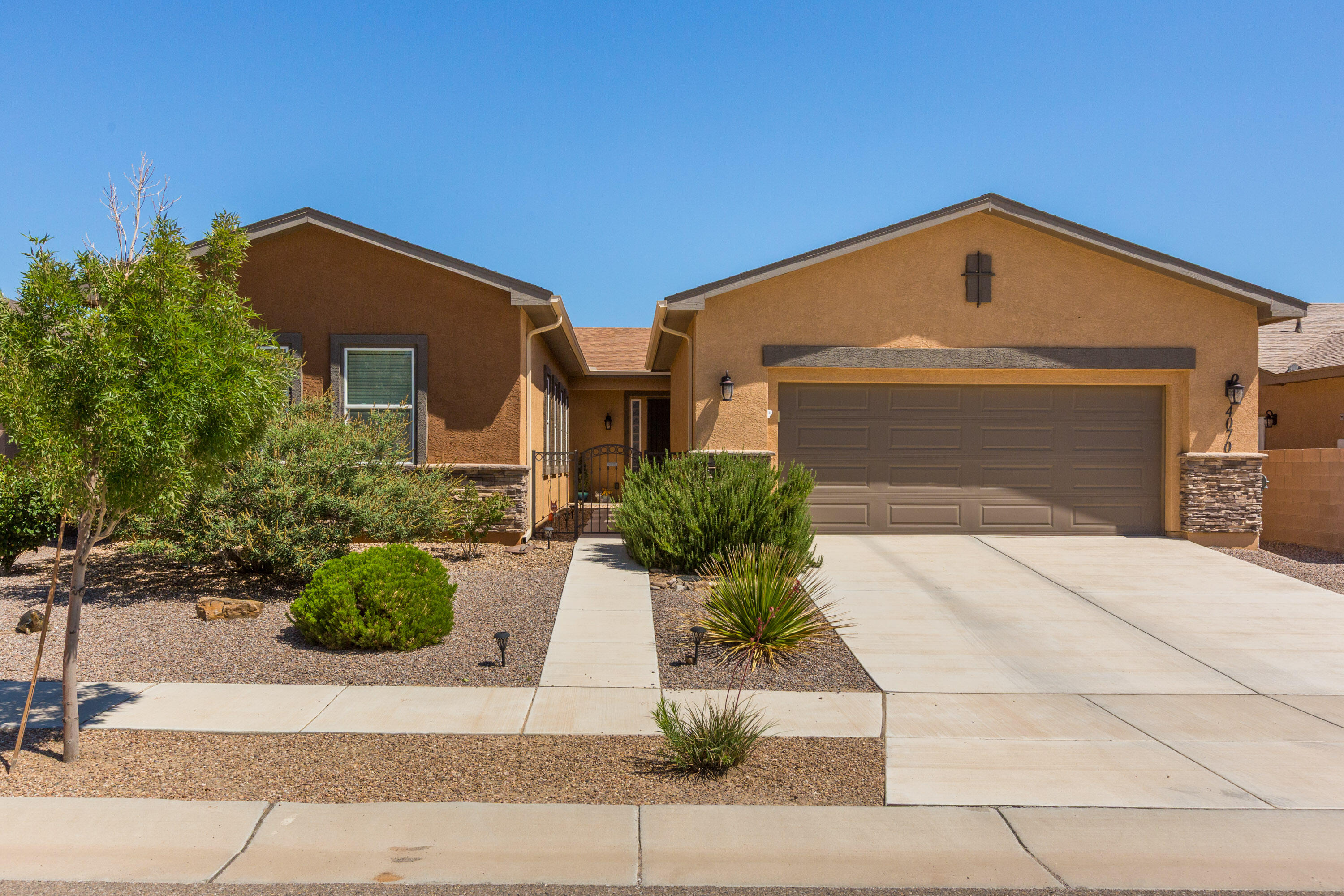 Welcome Home to Jubilee,  Los Lunas' premier Active Adult Gated Community! Built in 2019, and lovingly cared for by the Original Owner, this gorgeous home offers 2,255 square feet of thoughtfully designed living space, a wonderful open floorplan and plenty of room for both everyday living and entertaining! Step inside to a spacious Living Room that flows beautifully into the Kitchen and Dining areas, creating an open and inviting gathering space. The Kitchen features granite countertops, abundant cabinetry, a pantry and plenty of workspace for cooking and entertaining. ALL APPLIANCES STAY! Attractive LVP flooring extends throughout the Kitchen, Dining area, Office and hallways for a stylish and easy-care finish. The spacious Primary Suite is a relaxing retreat featuring a large walk-in closet and an impressive bath with a zero-threshold tiled shower with grab bar, double sinks and plenty of room to start and end your day comfortably. Guests will appreciate the generously sized Second En-Suite with its own full bath, providing wonderful privacy and flexibility. An additional half bath is conveniently located for visitors.Need a dedicated workspace, hobby room or quiet retreat? The separate Office with French doors provides the perfect space while still feeling connected to the rest of the home. Anyone needing extra storage will LOVE the oversized 23'10'' x 29' Garage! Complete with a utility/mud sink, shelving and workbench, there's plenty of space for vehicles, projects, storage and more. Step outside and enjoy the privacy of the backyard and a large covered patio--an ideal spot for morning coffee, relaxing in the shade or entertaining family and friends. And the lifestyle is just as special as the home! Jubilee residents enjoy a beautiful Clubhouse offering daily activities and numerous amenities, including gathering spaces, a billiard room, library, fully equipped fitness center, Jr. Olympic-size outdoor pool, Jacuzzi and more. Whether you prefer staying active, meeting neighbors or simply relaxing and enjoying your surroundings, Jubilee offers something for everyone. Jubilee is minutes to I-25 and about 20 minutes to Albuquerque! Beautiful home, fantastic garage, private outdoor living and wonderful community amenities--come see everything this special Jubilee home has to offer!